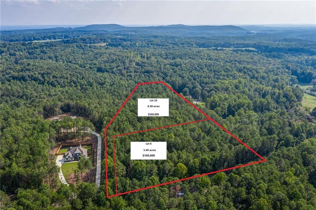 3237 Land Road Waleska, GA 30183 - Photo 1 of 1 a view of a lush green forest with a house in the background