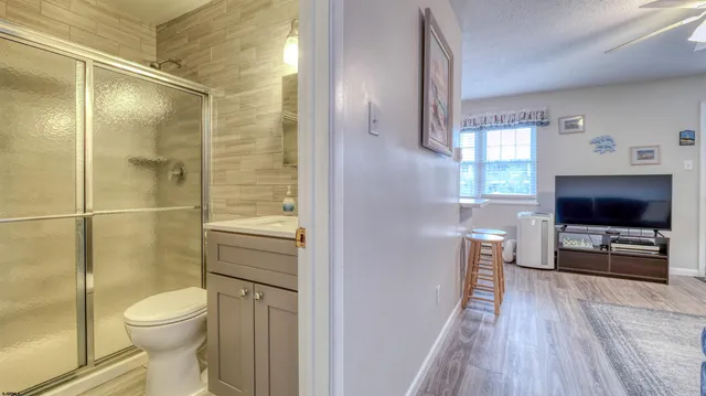 a bathroom with a toilet a sink and a large mirror