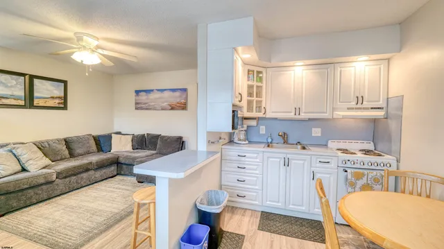 a living room with furniture and a dining table