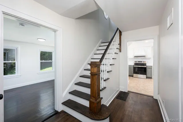 a view of entryway and hall with wooden floor