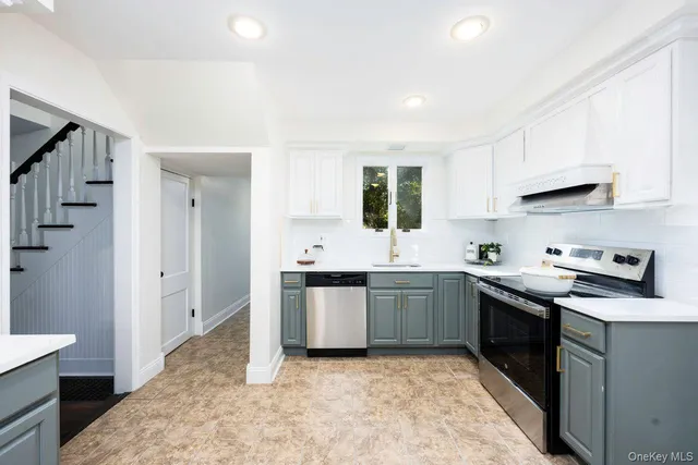 a kitchen with stainless steel appliances granite countertop a stove sink and cabinets