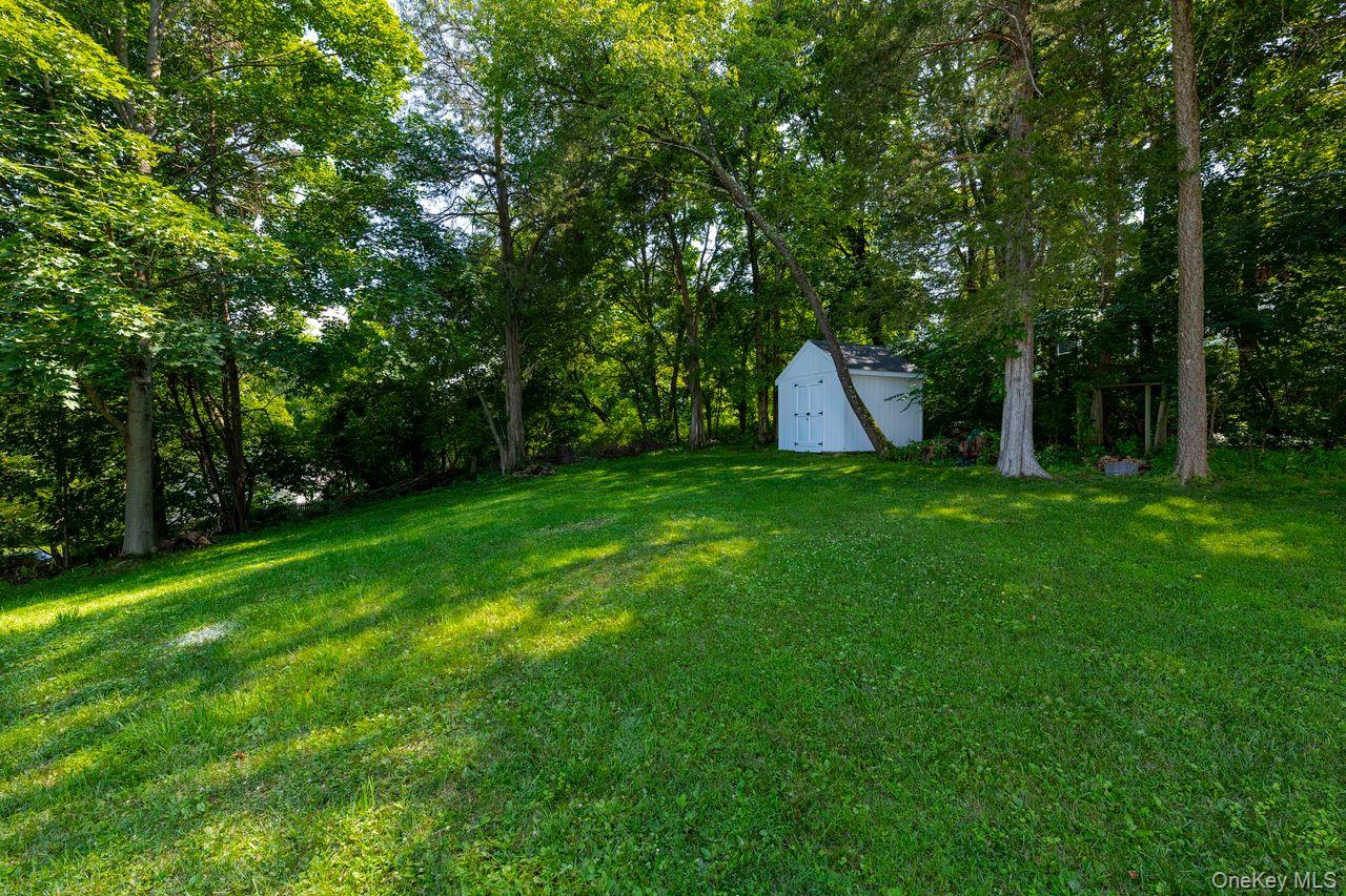 2123 New Hackensack Road Poughkeepsie, NY 12603 - Photo 27 of 30 a view of a house with a backyard and a tree