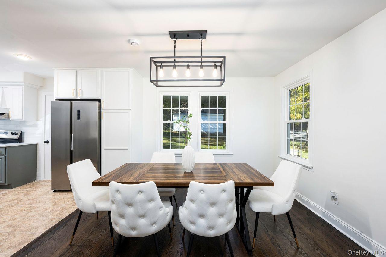 2123 New Hackensack Road Poughkeepsie, NY 12603 - Photo 5 of 30 a dining room with furniture a chandelier and wooden floor