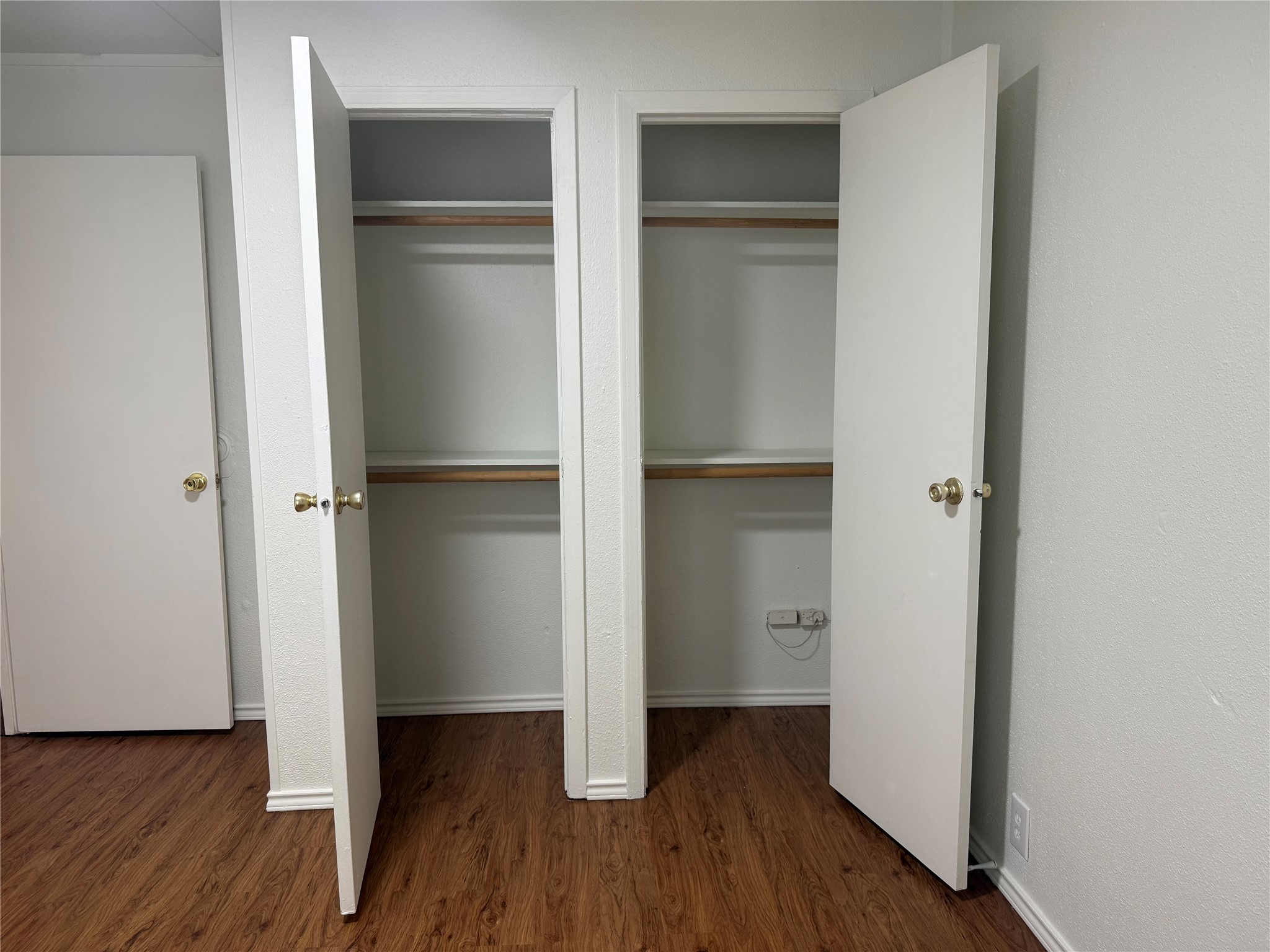 23393 Nameless Road, Unit 112 Leander, TX 78641 - Photo 16 of 16 Dual closets open to reveal built-in shelving above rich wood flooring.
