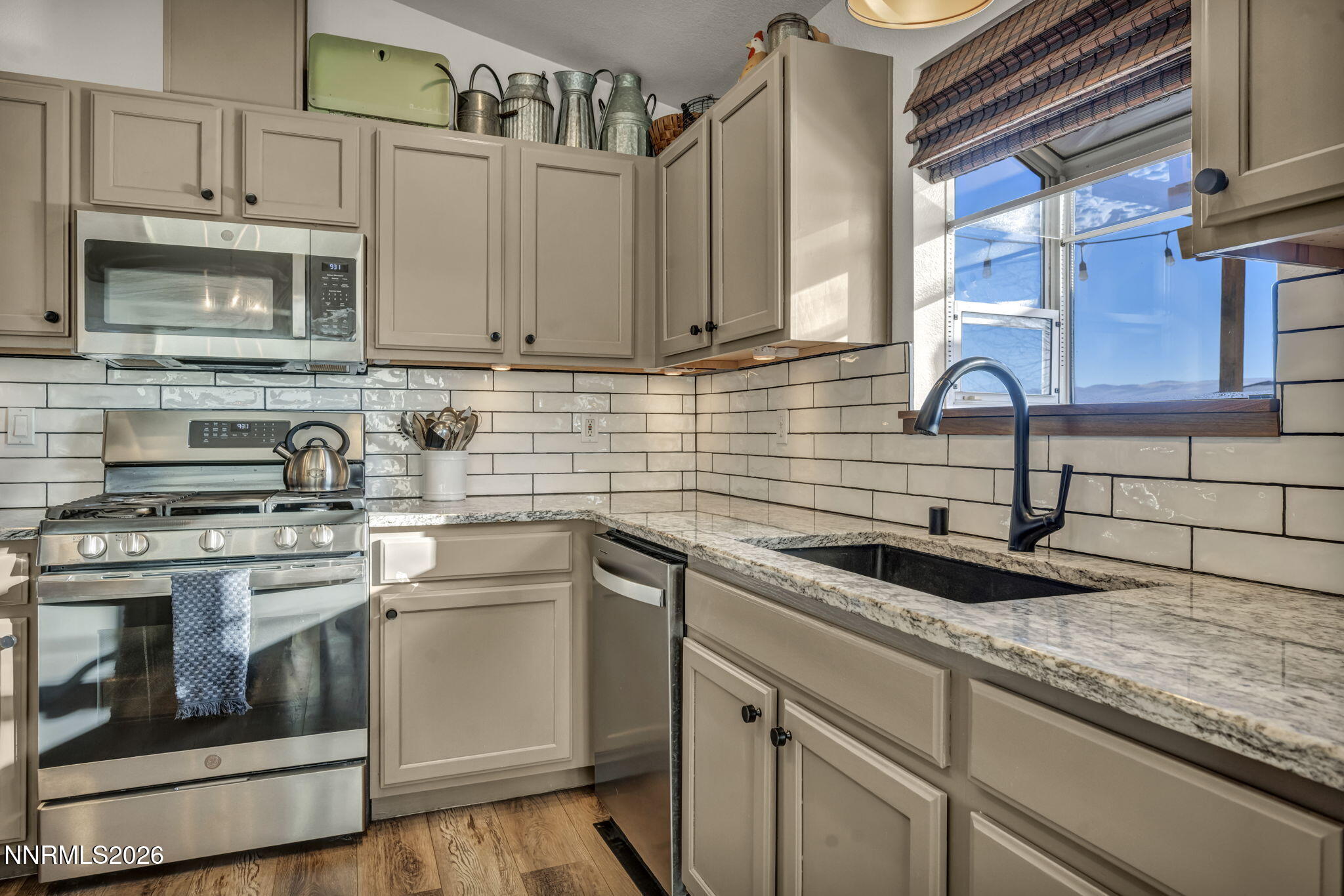 952 Red Falcon Way Spanish Springs, NV 89441 - Photo 11 of 46 a kitchen with stainless steel appliances granite countertop a sink a stove and cabinets