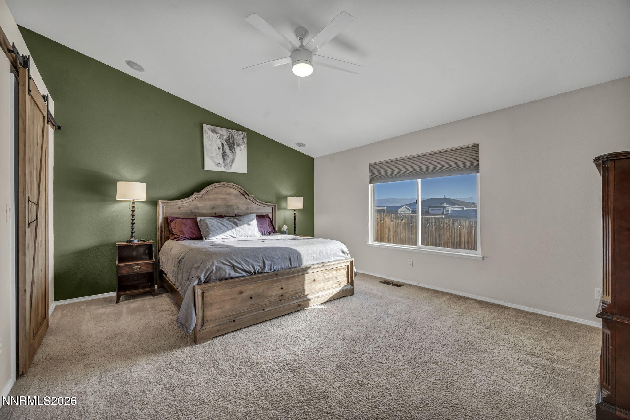 952 Red Falcon Way Spanish Springs, NV 89441 - Photo 15 of 46 a bedroom with a bed chandelier and a window