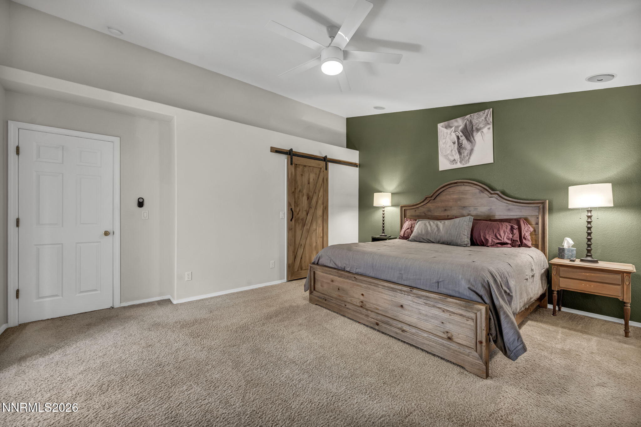 952 Red Falcon Way Spanish Springs, NV 89441 - Photo 16 of 46 a bedroom with a large bed and a chandelier