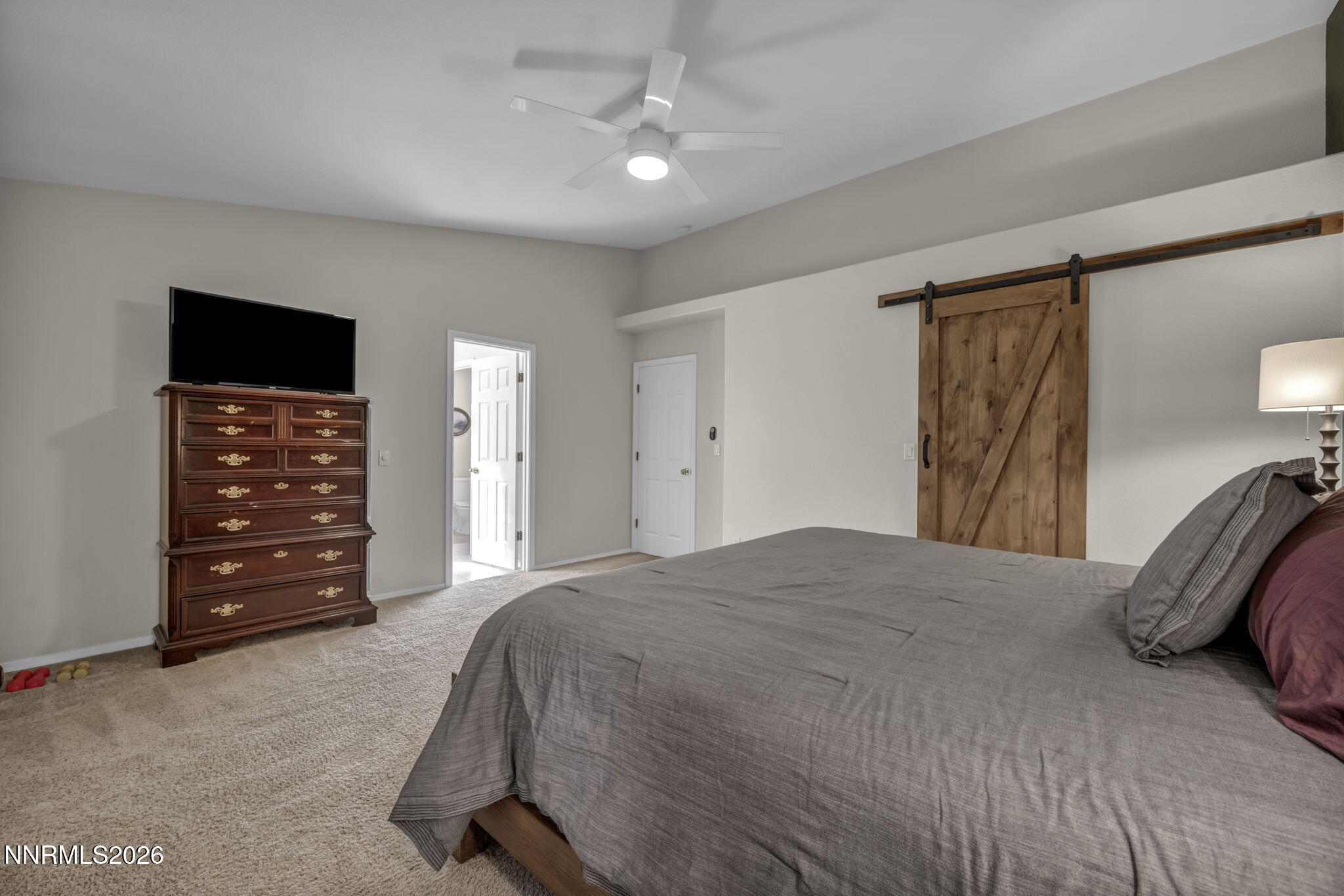 952 Red Falcon Way Spanish Springs, NV 89441 - Photo 17 of 46 a bedroom with a bed and a television