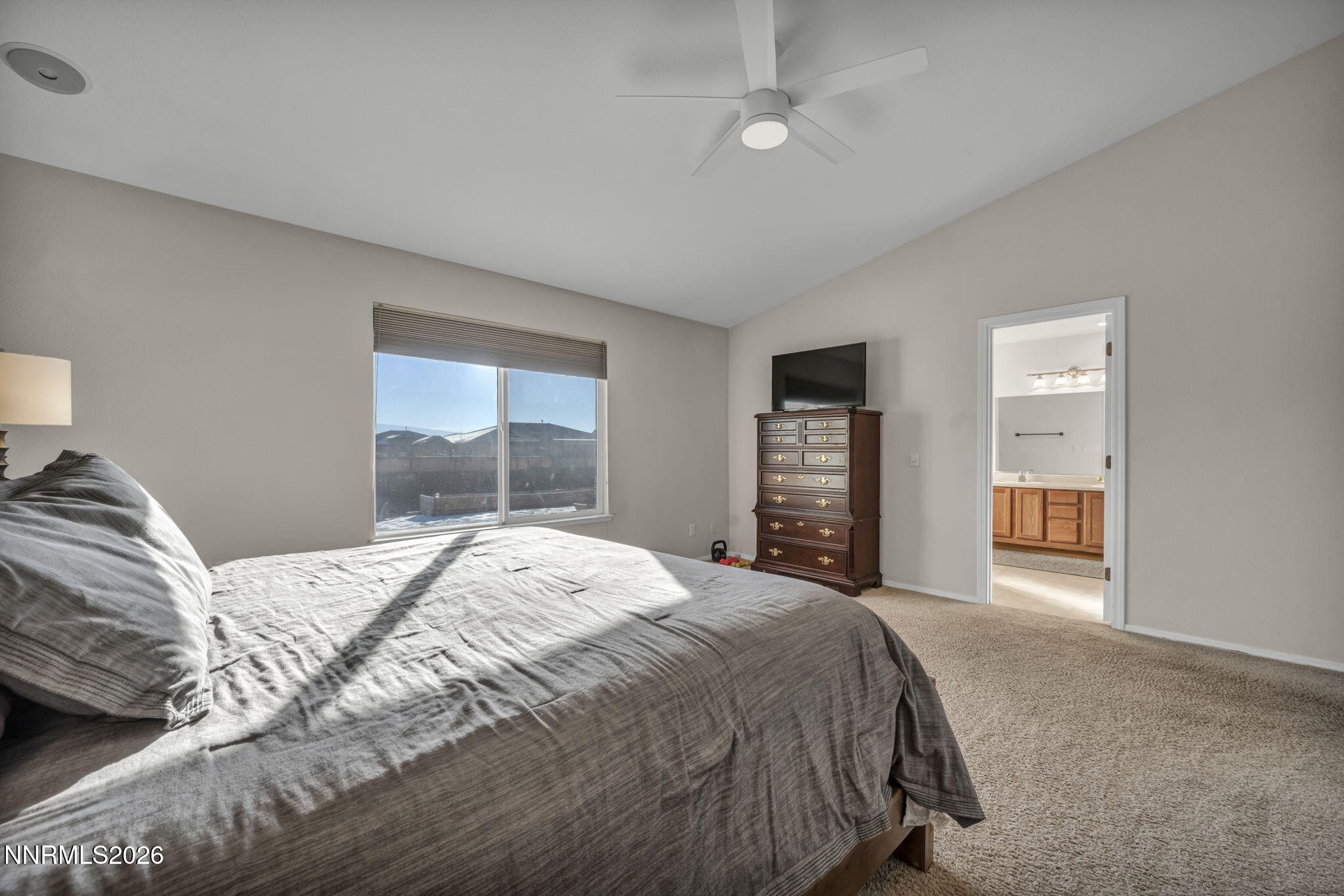 952 Red Falcon Way Spanish Springs, NV 89441 - Photo 18 of 46 a bedroom with a large bed and a window