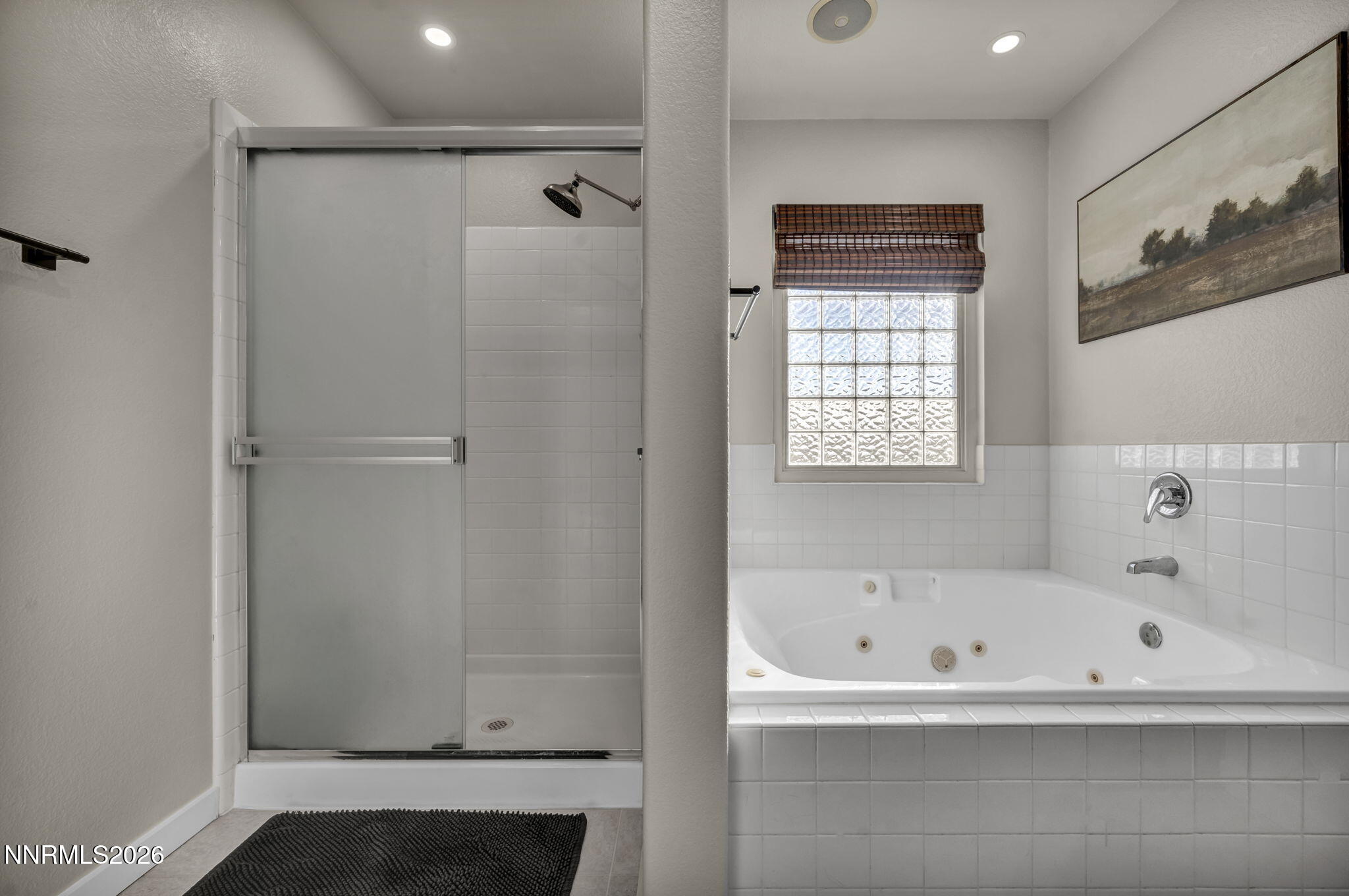 952 Red Falcon Way Spanish Springs, NV 89441 - Photo 22 of 46 a bathroom with a bathtub and a shower