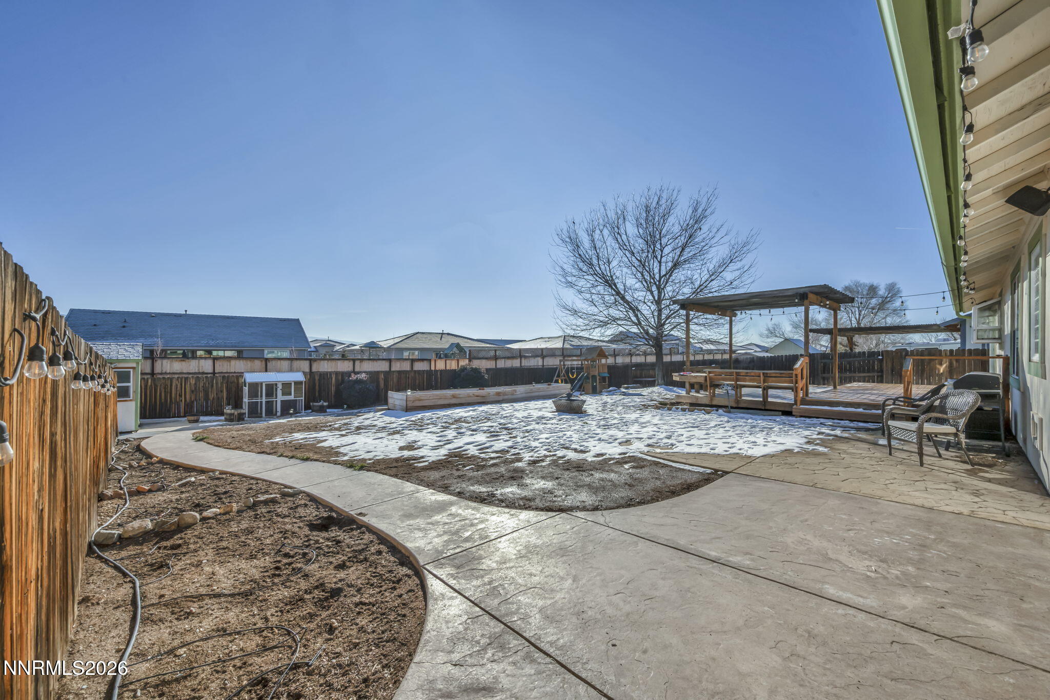 952 Red Falcon Way Spanish Springs, NV 89441 - Photo 34 of 46 a view of a backyard with table and chairs under an umbrella
