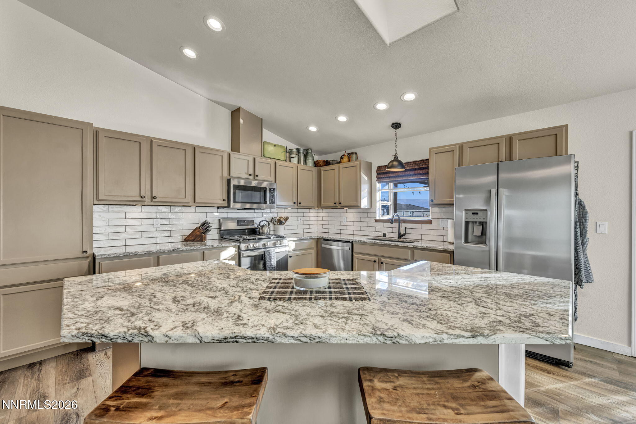 952 Red Falcon Way Spanish Springs, NV 89441 - Photo 8 of 46 a kitchen with stainless steel appliances granite countertop a sink refrigerator and cabinets