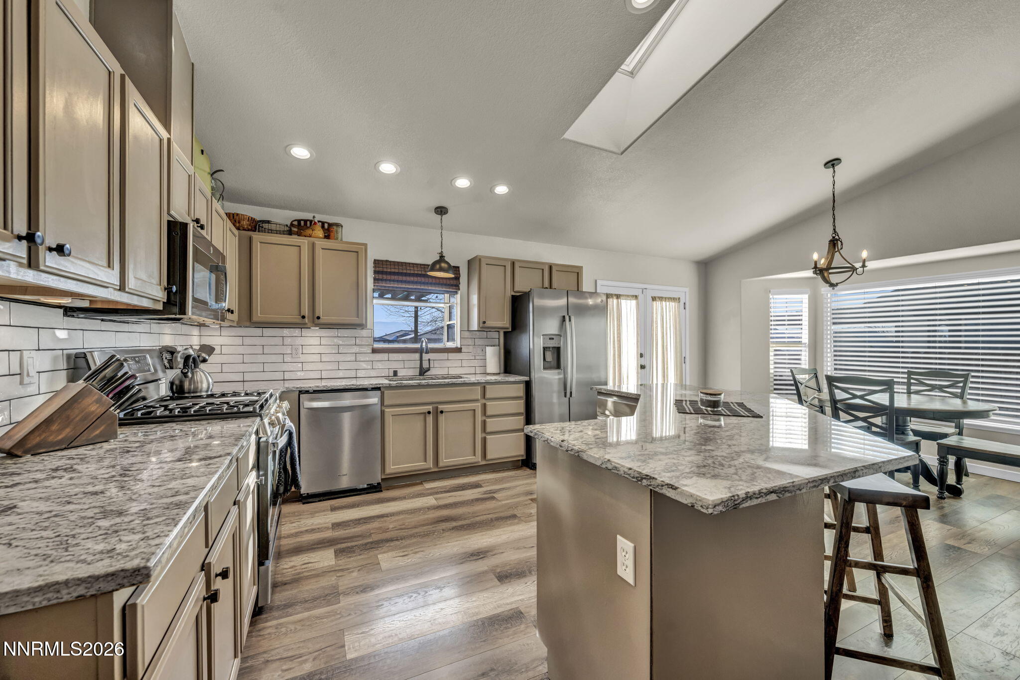 952 Red Falcon Way Spanish Springs, NV 89441 - Photo 9 of 46 a kitchen with a sink stove cabinets and chairs