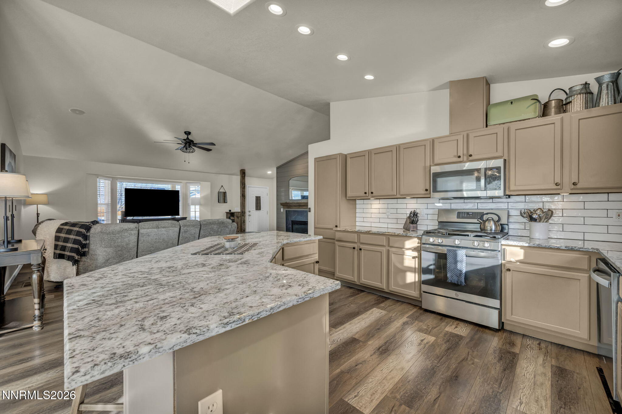 952 Red Falcon Way Spanish Springs, NV 89441 - Photo 10 of 46 a kitchen with stainless steel appliances granite countertop a sink stove and refrigerator