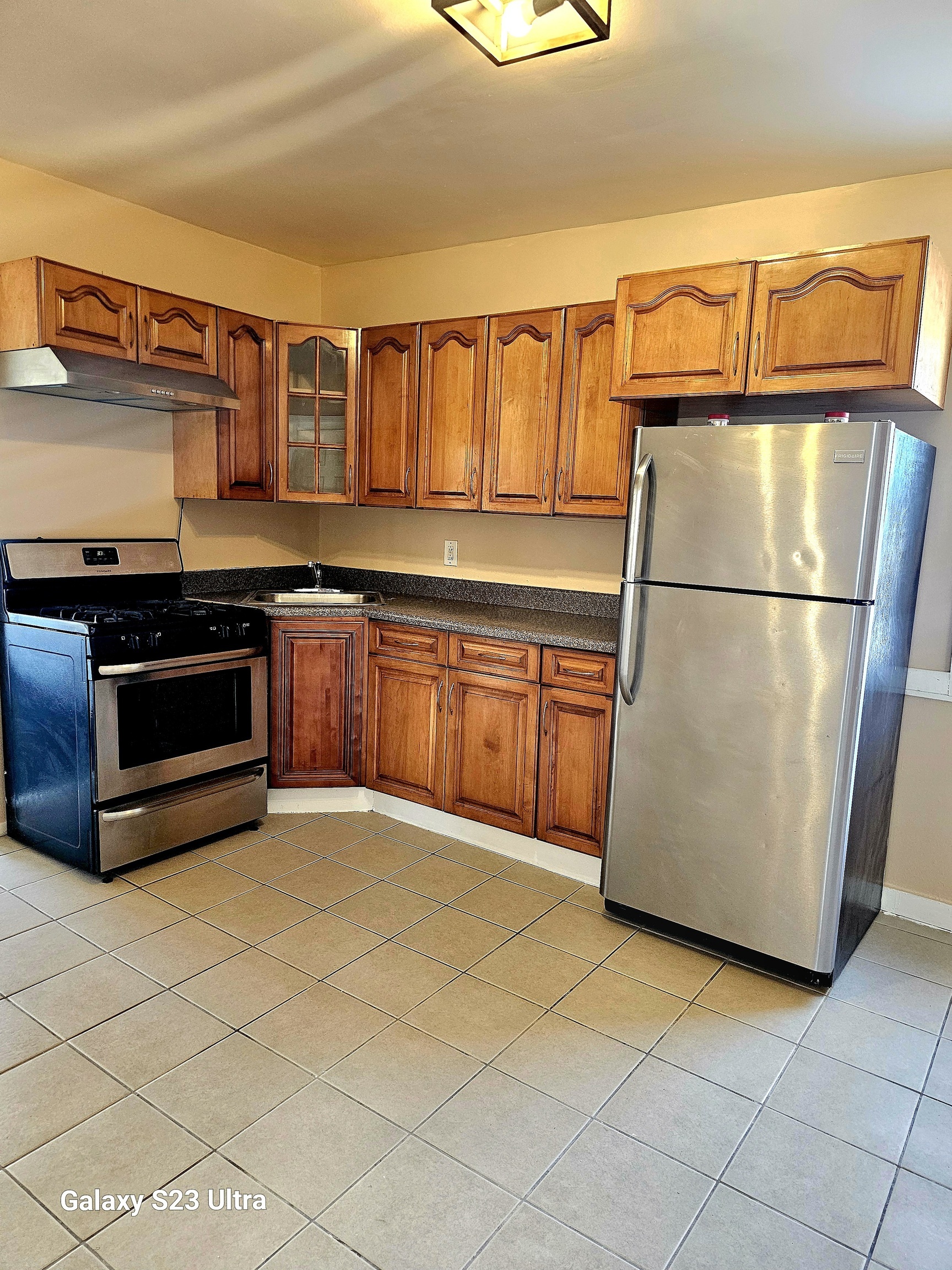 124 Division Street Waterbury, CT 06704 - Photo 3 of 12 a kitchen with stainless steel appliances granite countertop a refrigerator a stove and a sink with dishwasher