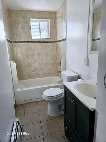 a bathroom with a sink a toilet and bathtub