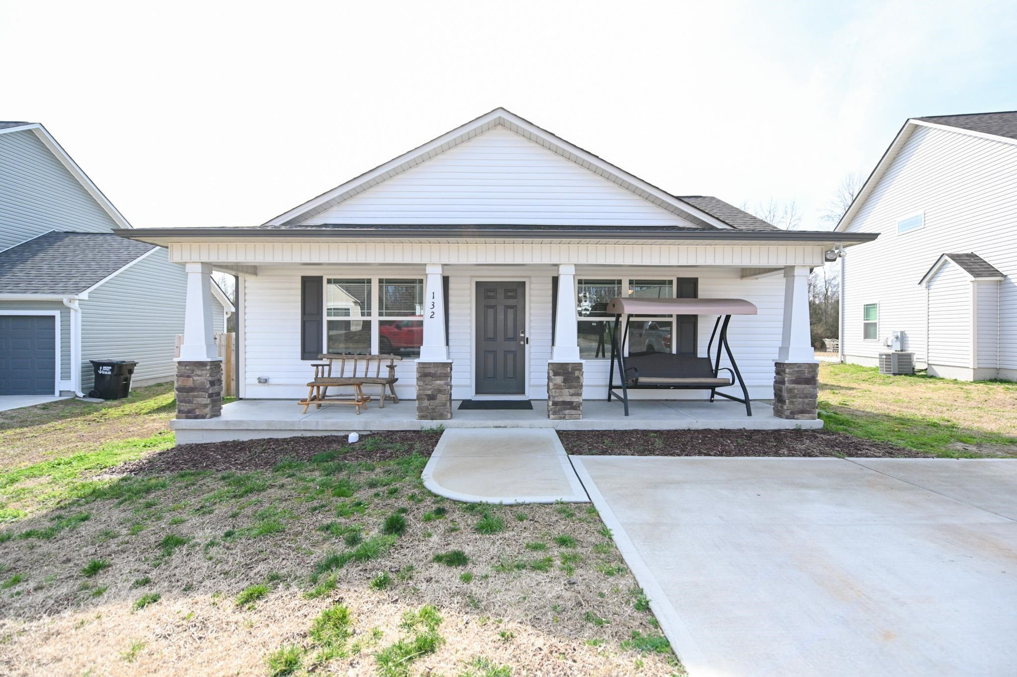 a view of a house with backyard and porch