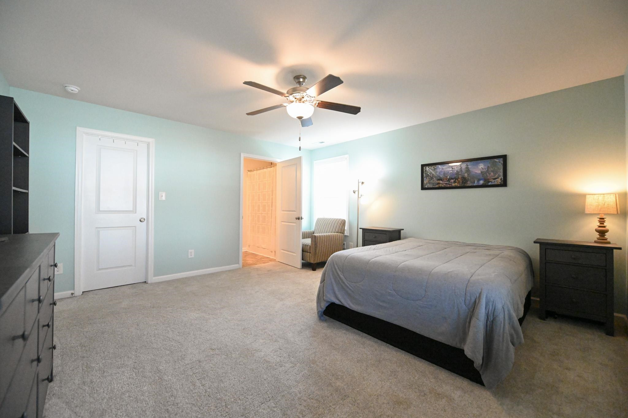 132 Winter Red Way Benson, NC 27504 - Photo 16 of 33 a bedroom with a bed and a chandelier