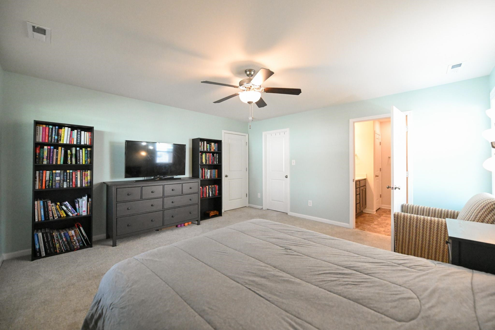 132 Winter Red Way Benson, NC 27504 - Photo 17 of 33 a bedroom with a bed and a flat screen tv