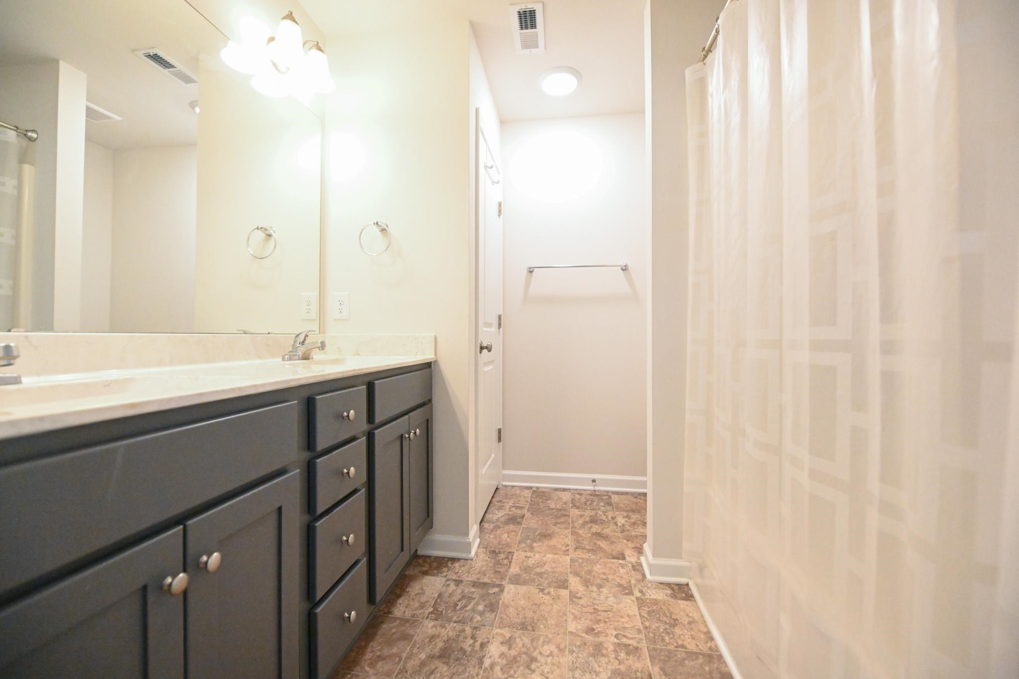 132 Winter Red Way Benson, NC 27504 - Photo 18 of 33 a bathroom with a double vanity sink a mirror and a shower