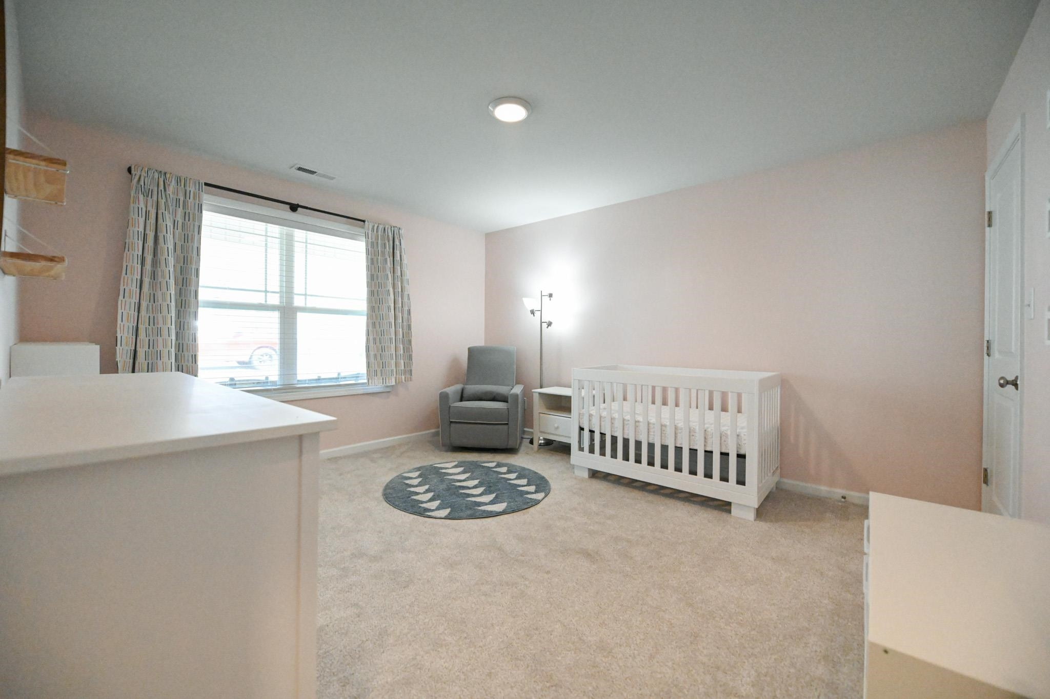 132 Winter Red Way Benson, NC 27504 - Photo 20 of 33 a spacious bedroom with a bed and a table