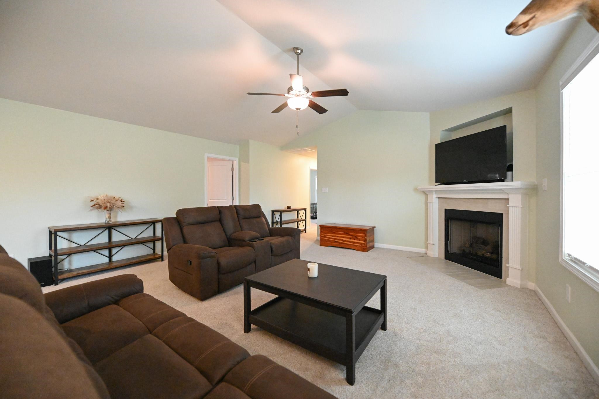 132 Winter Red Way Benson, NC 27504 - Photo 4 of 33 a living room with furniture a fireplace and a flat screen tv