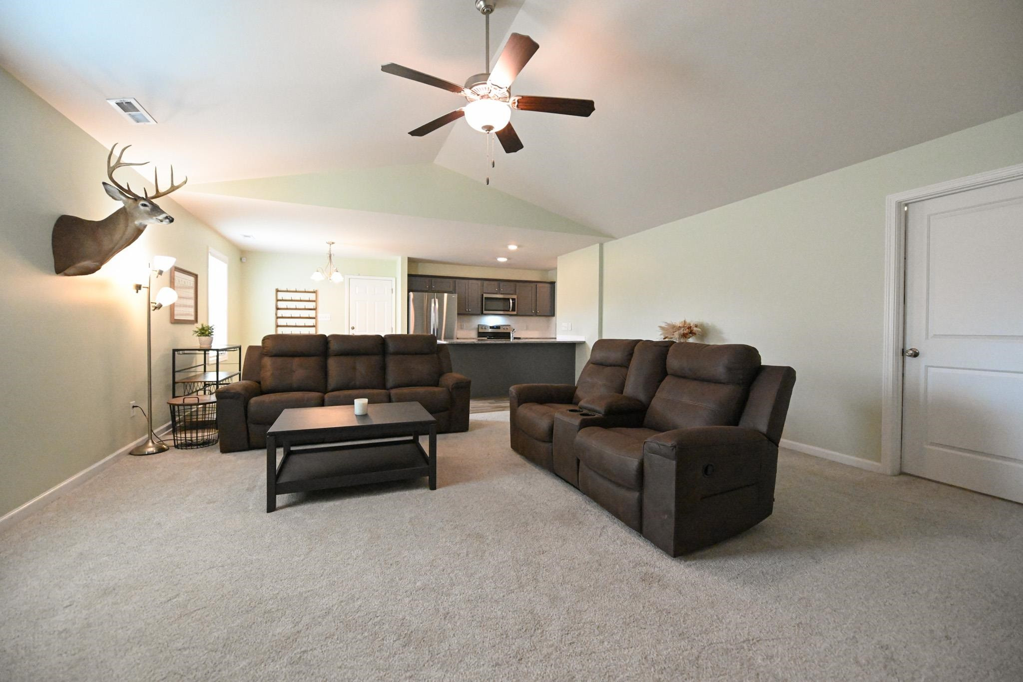 132 Winter Red Way Benson, NC 27504 - Photo 6 of 33 a living room with furniture a ceiling fan and a ceiling fan