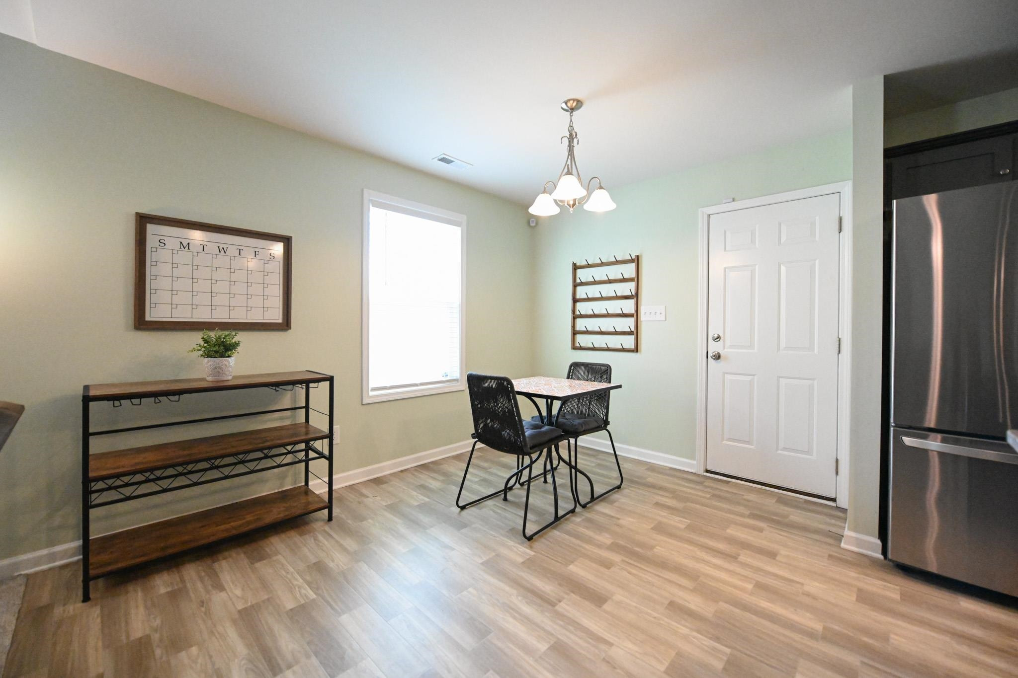 132 Winter Red Way Benson, NC 27504 - Photo 8 of 33 a view of a livingroom with furniture a ceiling fan and wooden floor