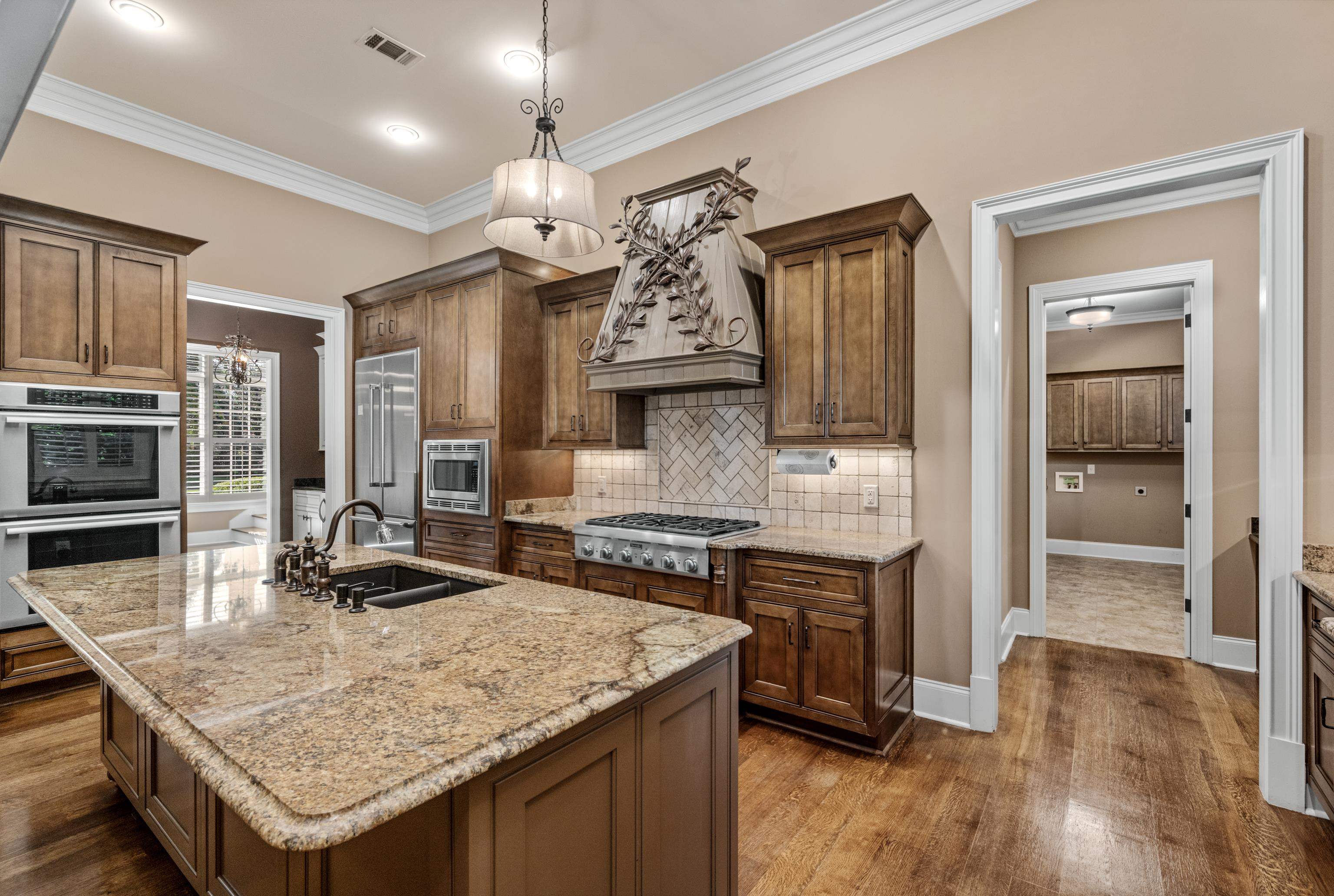 2840 Rue Jordan Cove Germantown, TN 38138 - Photo 12 of 40 a kitchen with granite countertop a stove refrigerator and wooden floor