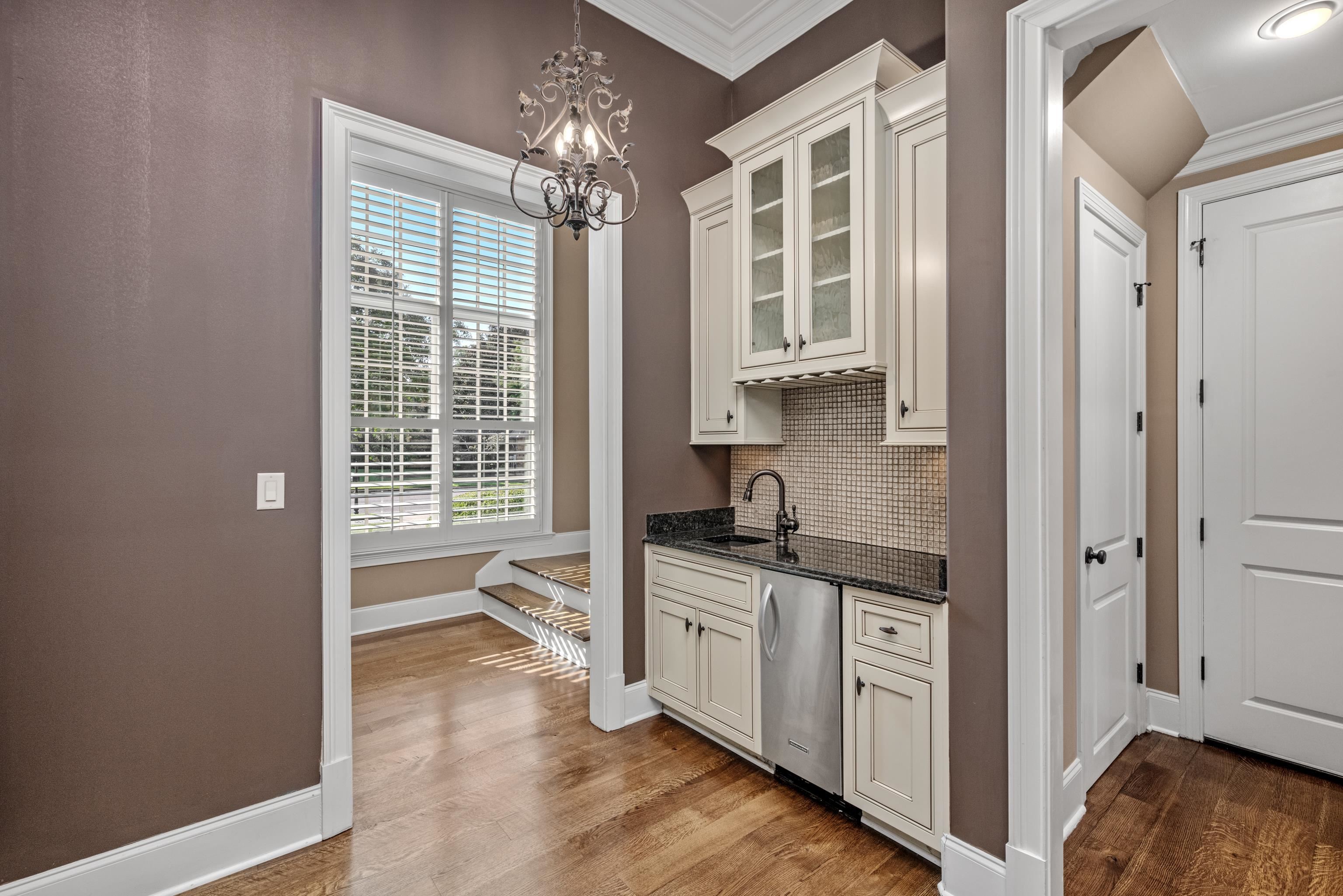 2840 Rue Jordan Cove Germantown, TN 38138 - Photo 17 of 40 a view of a kitchen with a sink and dishwasher with wooden floor