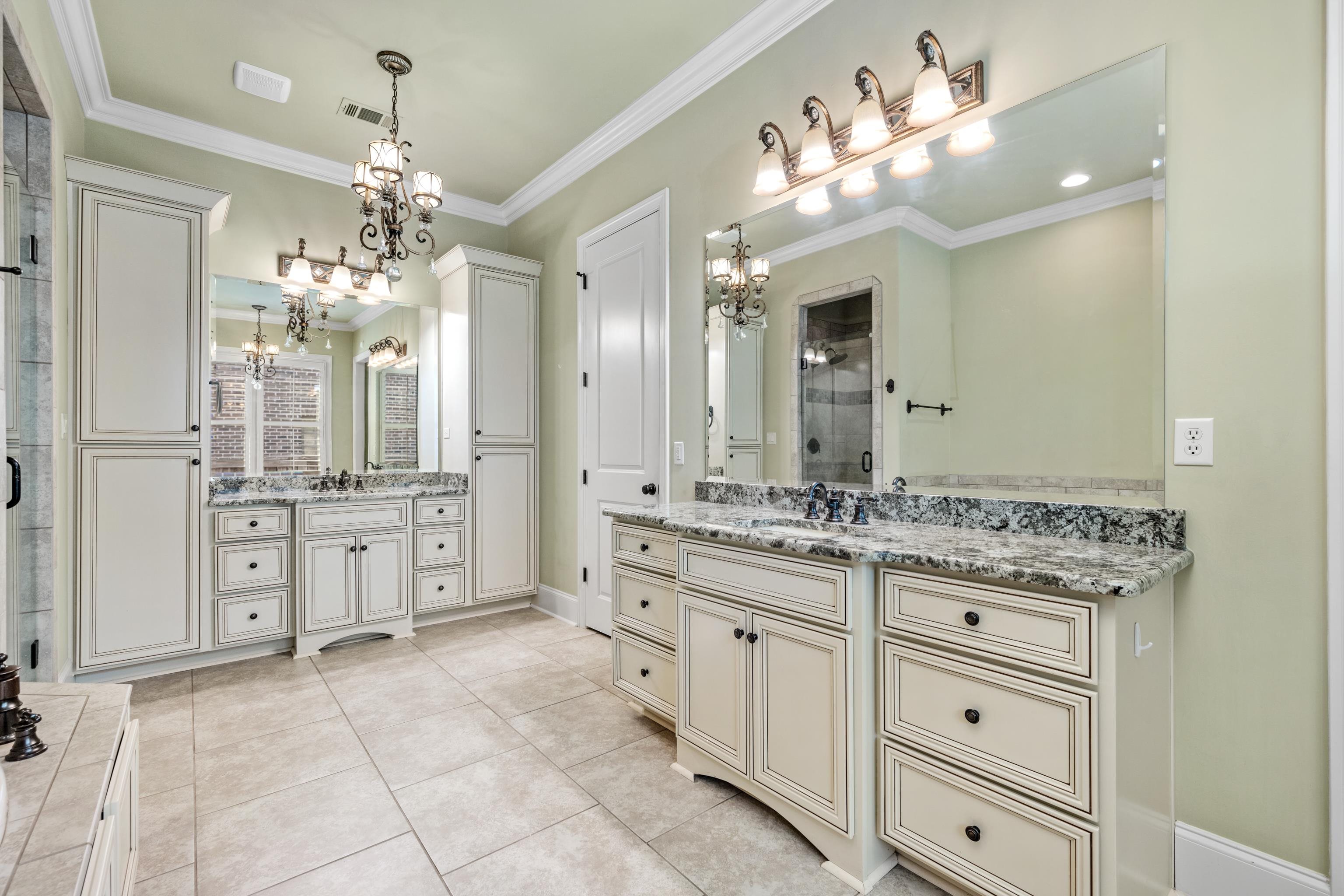 2840 Rue Jordan Cove Germantown, TN 38138 - Photo 24 of 40 a bathroom with a granite countertop sink a large mirror and a shower
