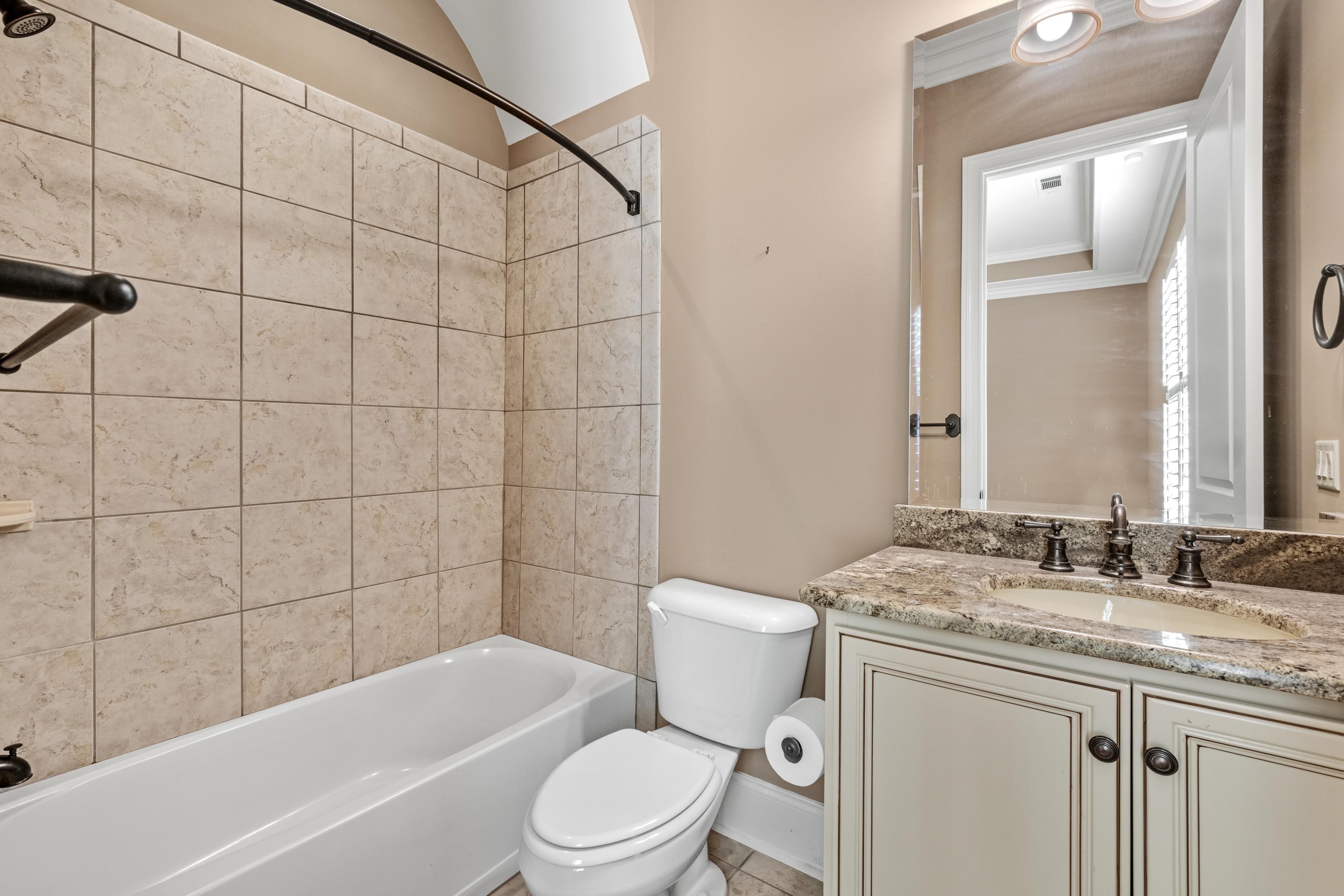 2840 Rue Jordan Cove Germantown, TN 38138 - Photo 27 of 40 a bathroom with a granite countertop bathtub shower sink mirror vanity and toilet