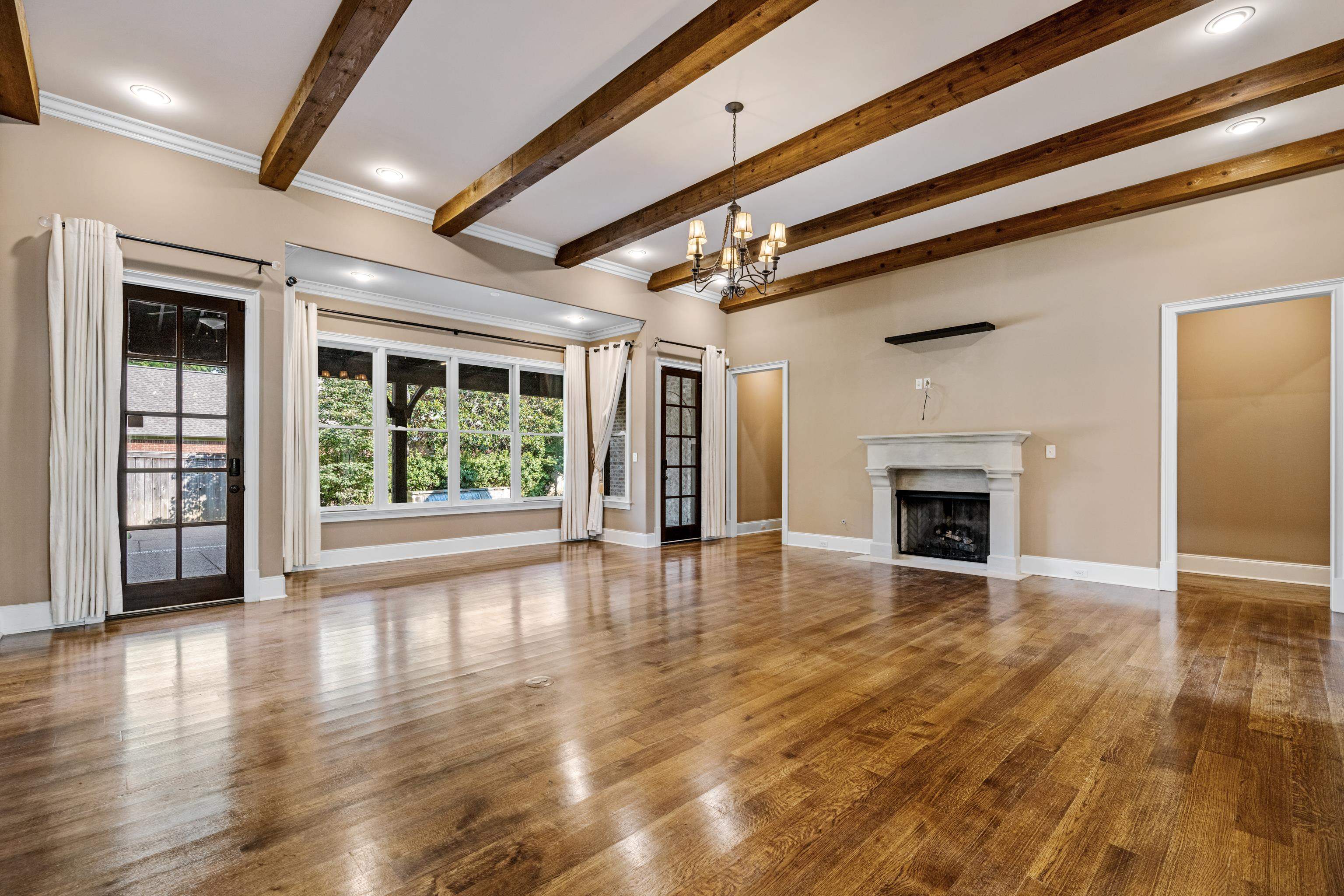 2840 Rue Jordan Cove Germantown, TN 38138 - Photo 7 of 40 a view of an empty room with wooden floor fireplace and a window
