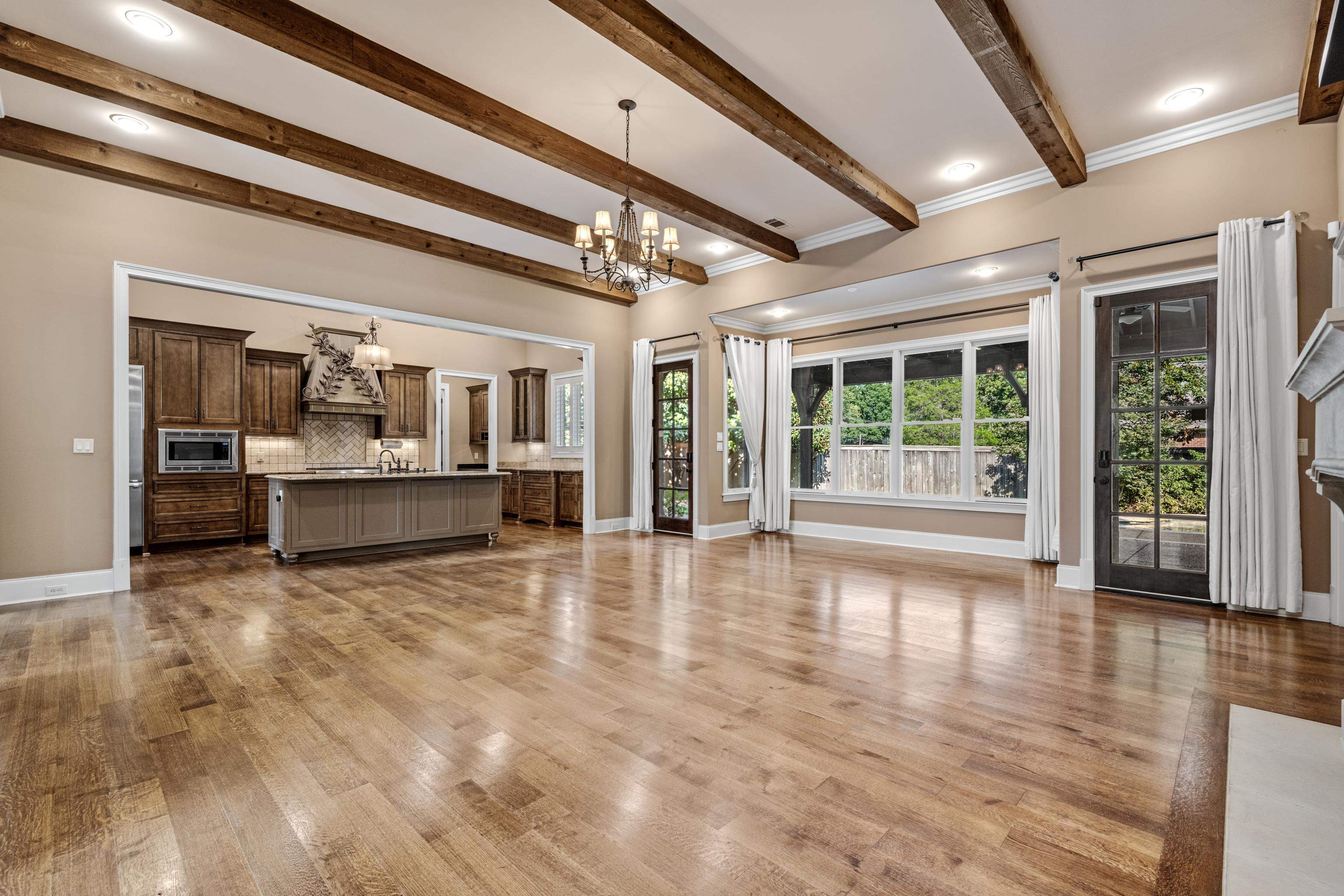 2840 Rue Jordan Cove Germantown, TN 38138 - Photo 9 of 40 a view of an empty room with wooden floor and a kitchen