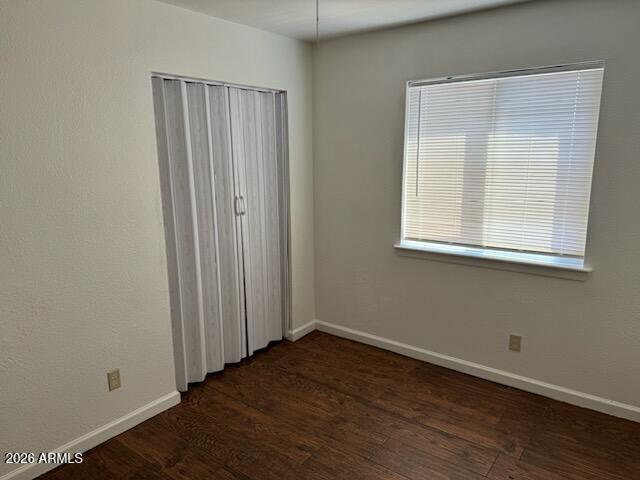 1319 West Vogel Avenue, Unit 3 Phoenix, AZ 85021 - Photo 4 of 5 an empty room with wooden floor and windows