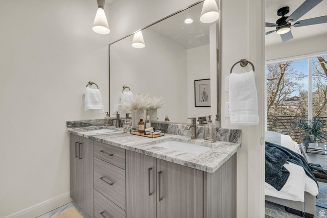 4016 South Burch Way Ogden, UT 84405 - Photo 15 of 30 Double vanity with gray wood-finish cabinetry, integrated sinks, and polished chrome faucets