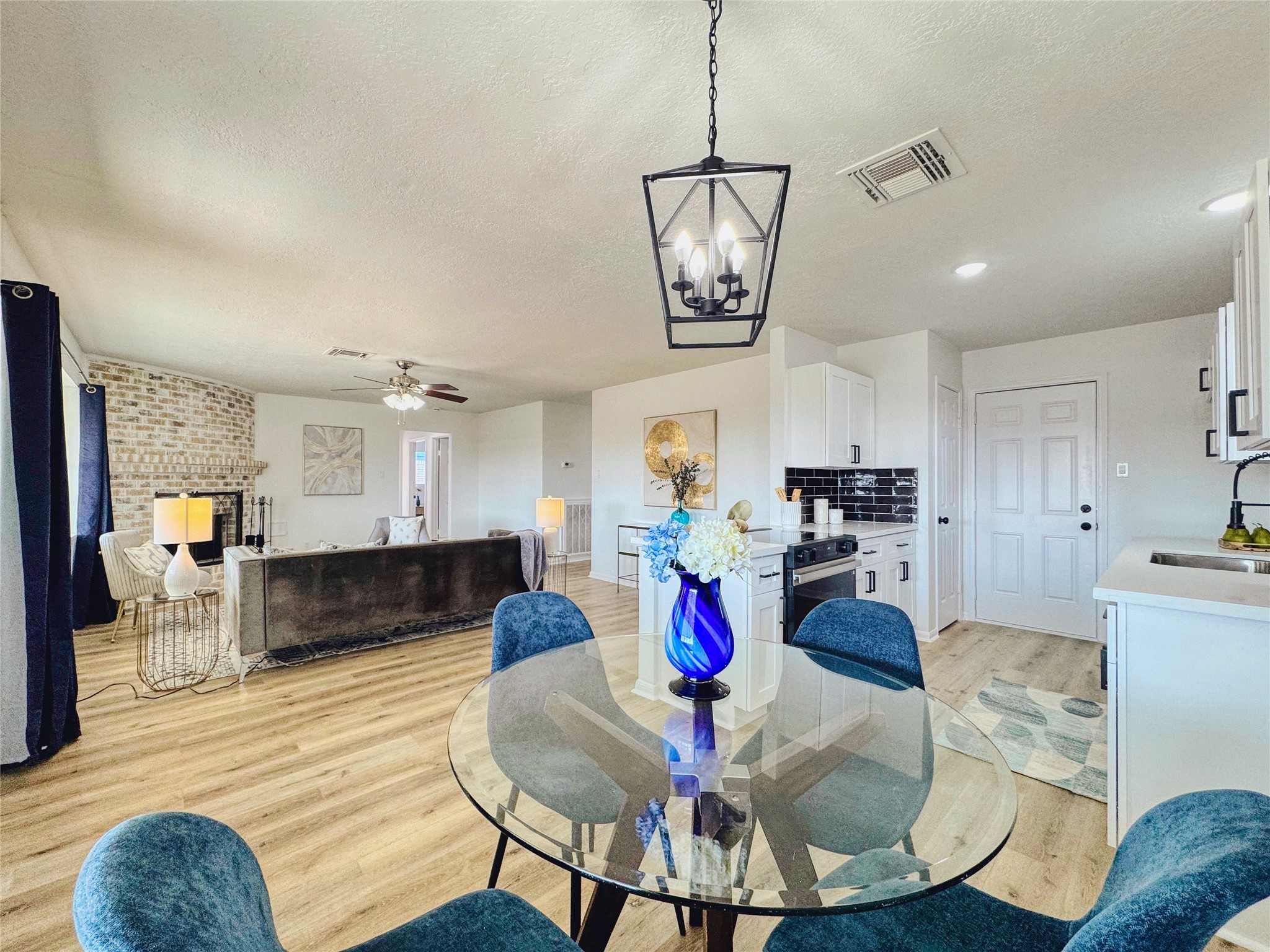3739 Moonlite Drive Pasadena, TX 77505 - Photo 11 of 32 a view of a dining room and livingroom with furniture wooden floor a chandelier