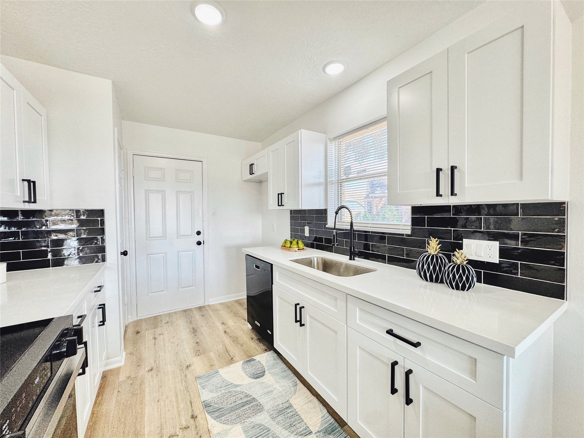 3739 Moonlite Drive Pasadena, TX 77505 - Photo 14 of 32 a kitchen with a sink a stove and cabinets