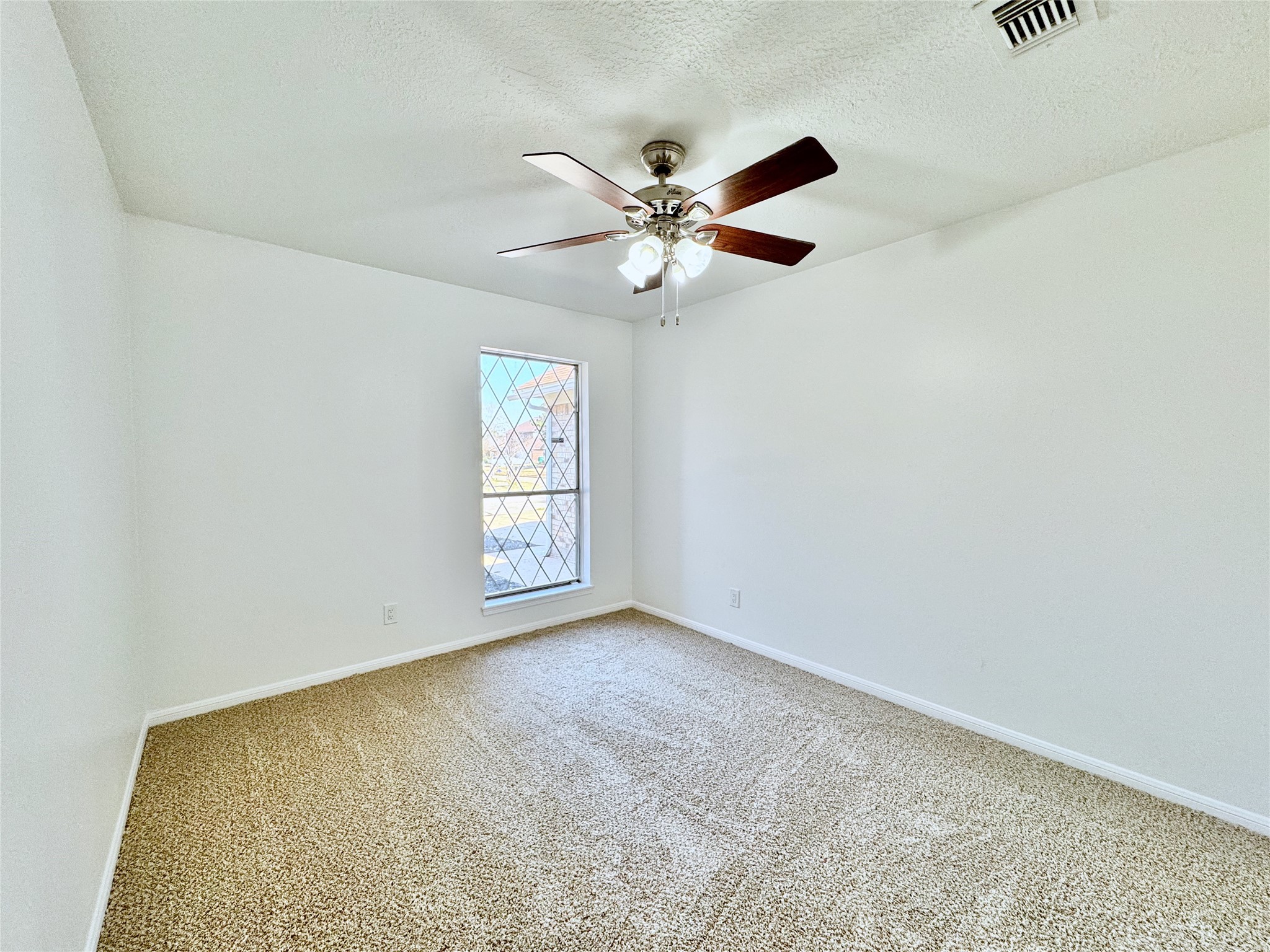 3739 Moonlite Drive Pasadena, TX 77505 - Photo 27 of 32 an empty room with windows and fan