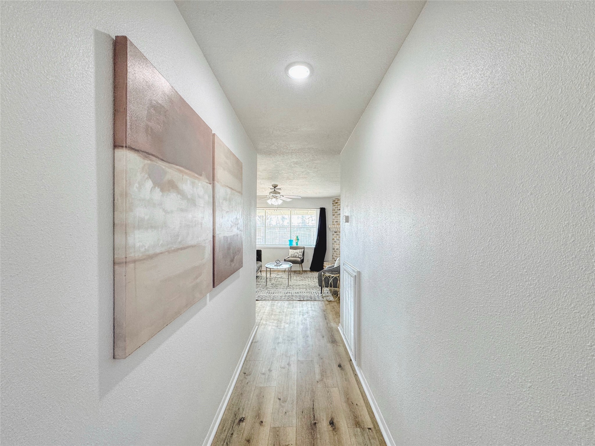 3739 Moonlite Drive Pasadena, TX 77505 - Photo 3 of 32 a view of a hallway with wooden floor and a bathroom