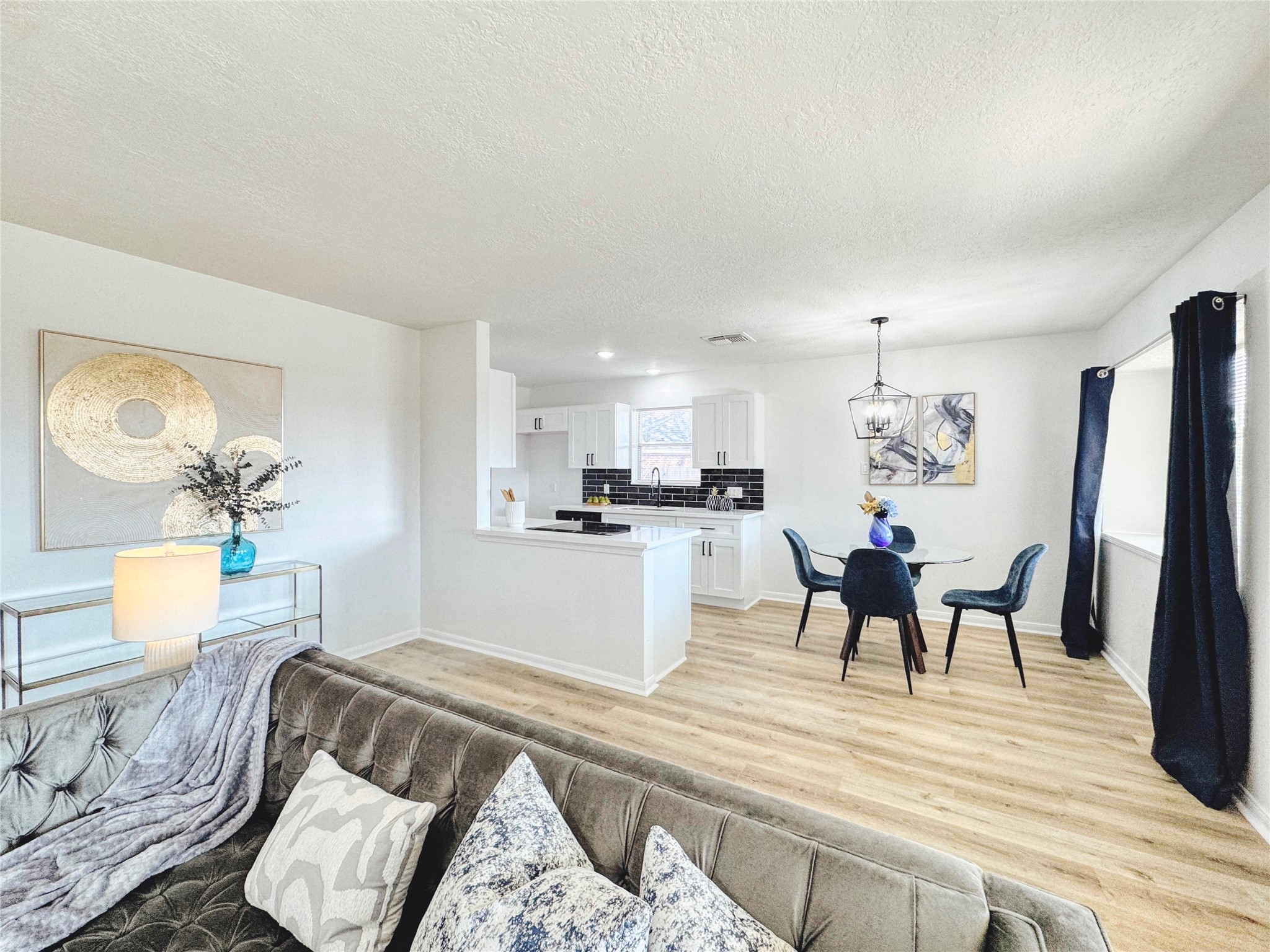 3739 Moonlite Drive Pasadena, TX 77505 - Photo 9 of 32 a living room with furniture and a dining table with kitchen view