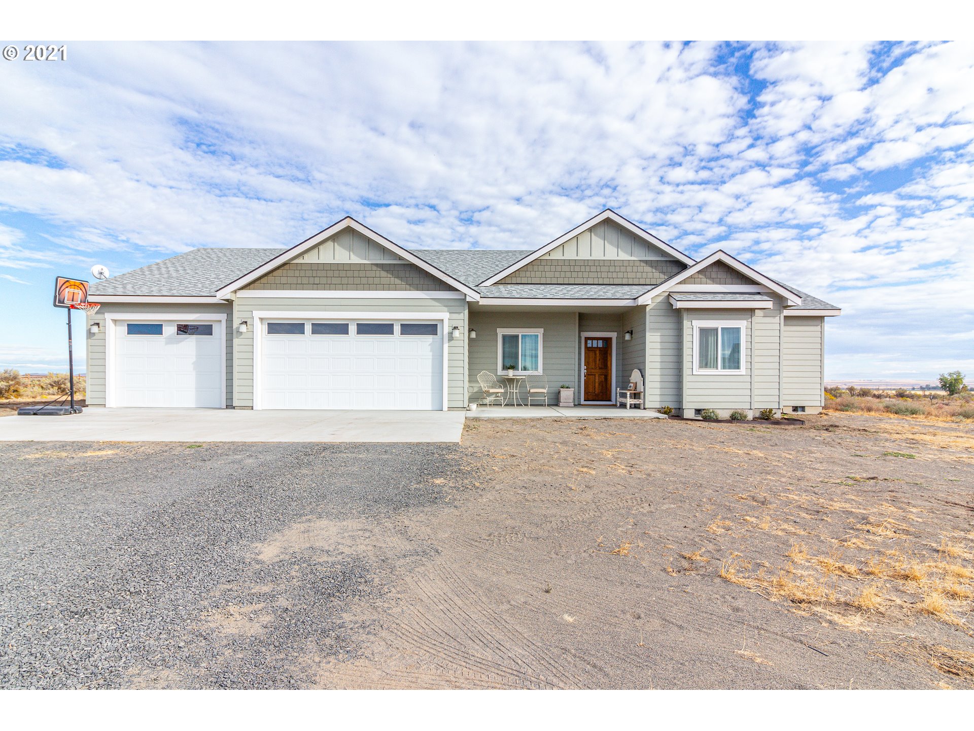 31931 Sun Ridge Lane Hermiston, OR 97838 - Photo 1 of 32 a view of a house with a yard and large tree