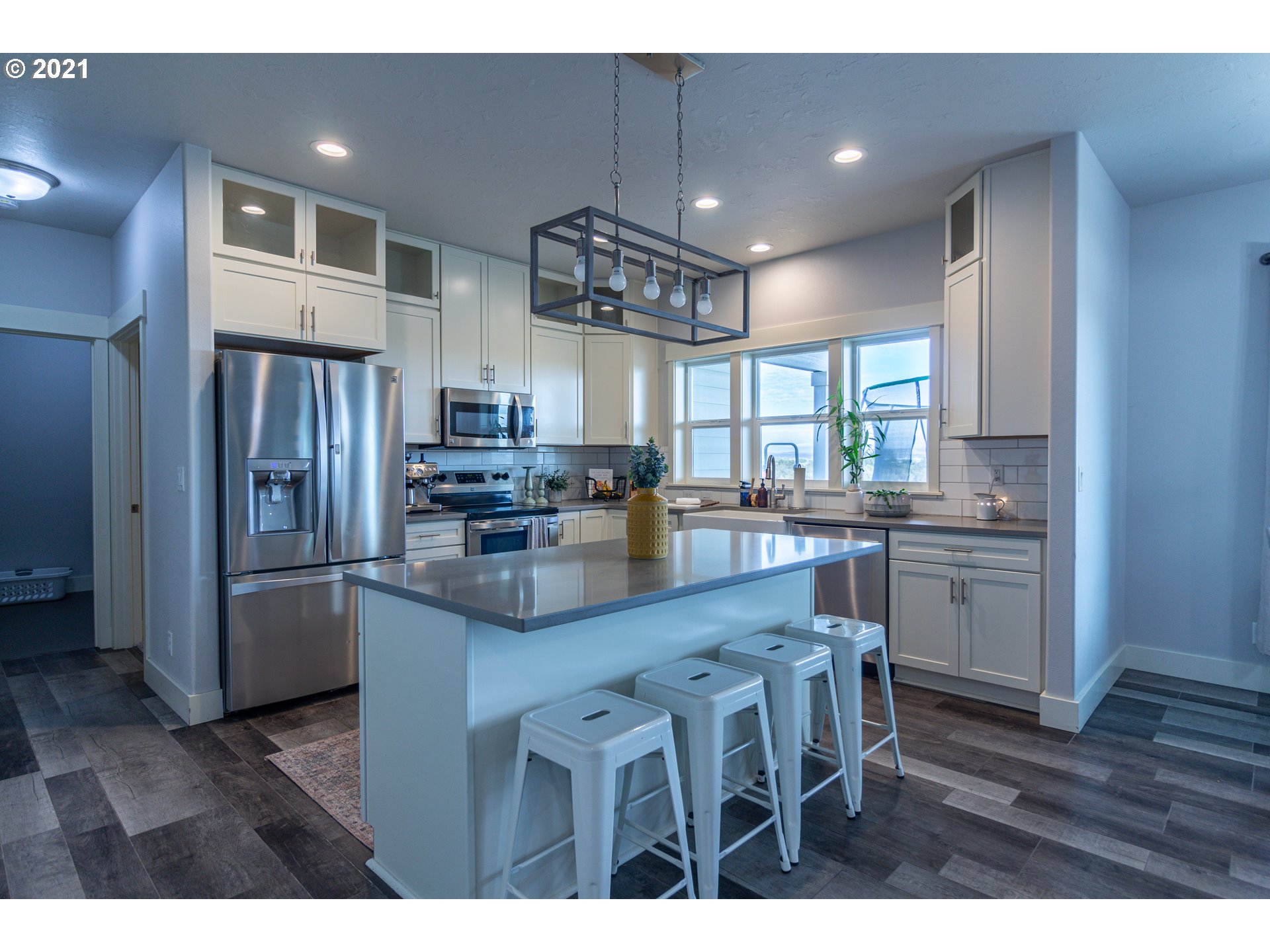 31931 Sun Ridge Lane Hermiston, OR 97838 - Photo 2 of 32 a kitchen with stainless steel appliances granite countertop a refrigerator a sink dishwasher a stove and a dining table with wooden floor