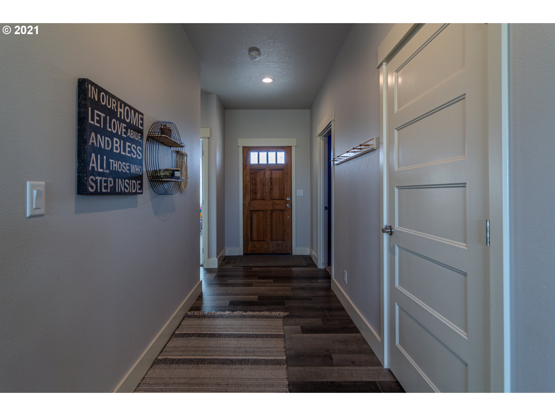 31931 Sun Ridge Lane Hermiston, OR 97838 - Photo 25 of 32 a view of a hallway with wooden floor