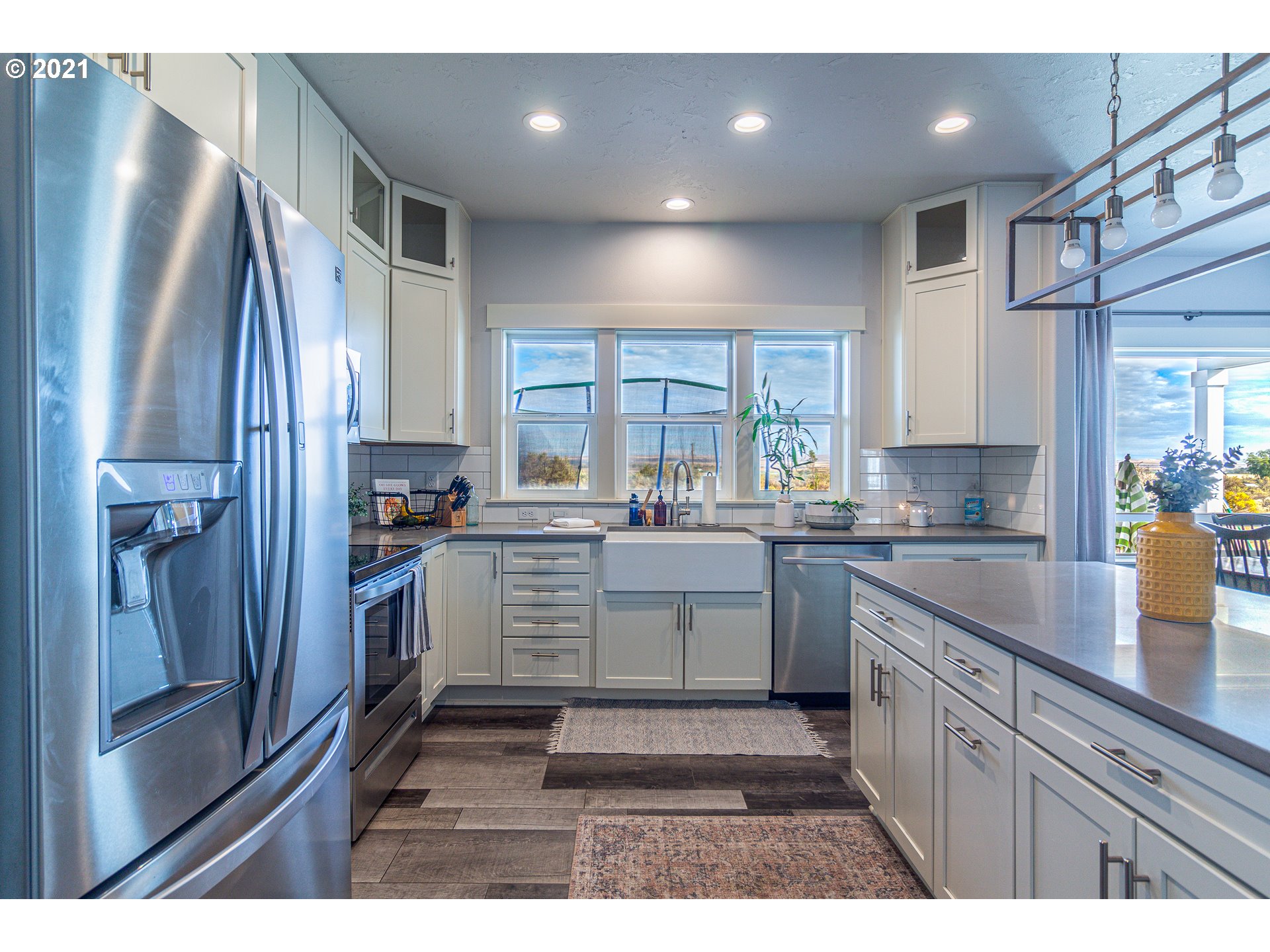 31931 Sun Ridge Lane Hermiston, OR 97838 - Photo 4 of 32 a kitchen with white cabinets and stainless steel appliances
