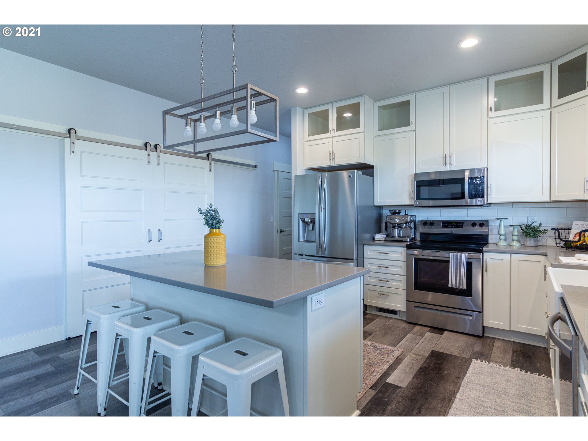 31931 Sun Ridge Lane Hermiston, OR 97838 - Photo 6 of 32 a kitchen with cabinets and stainless steel appliances