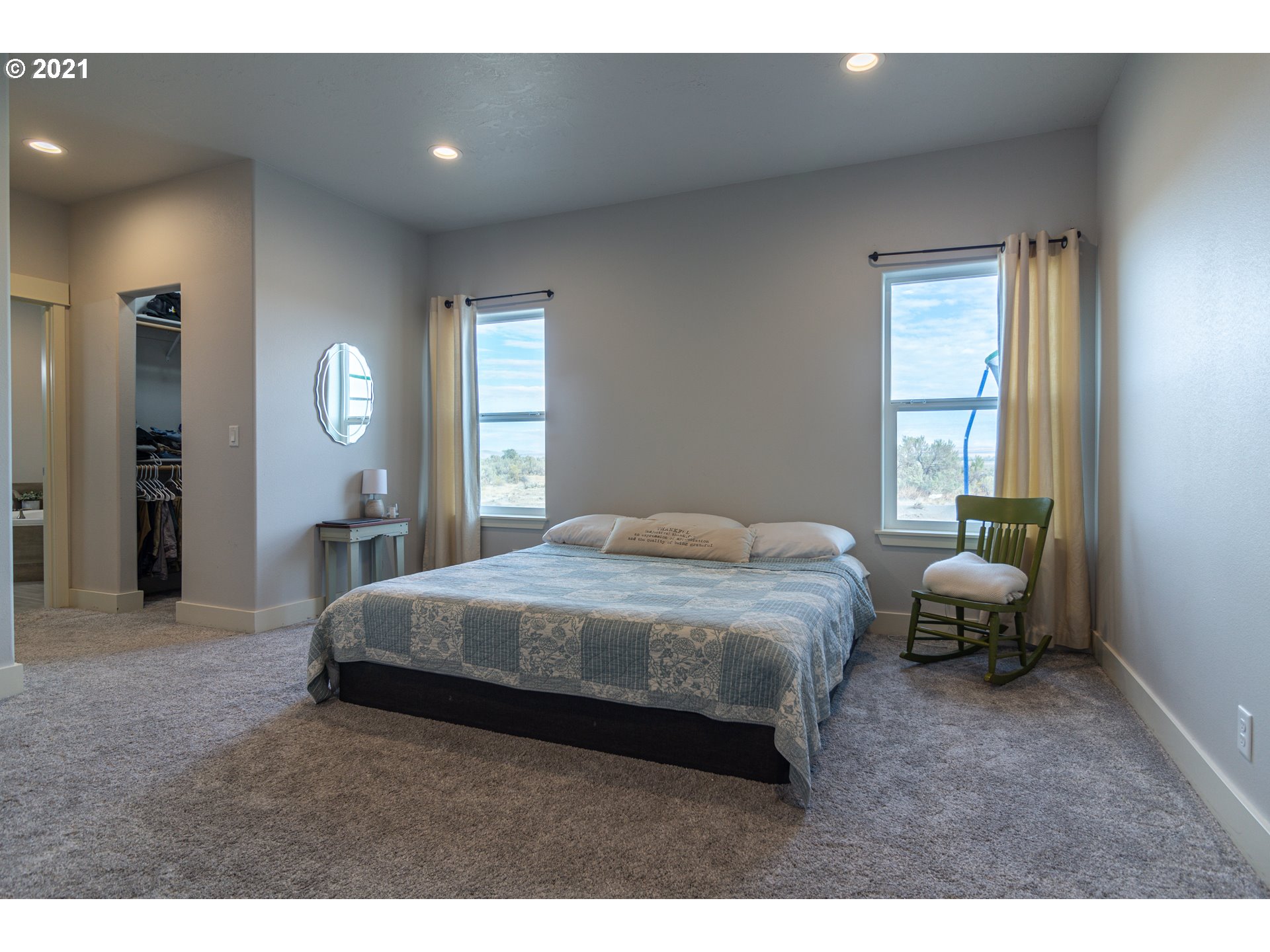 31931 Sun Ridge Lane Hermiston, OR 97838 - Photo 7 of 32 a bedroom with a bed and a chair