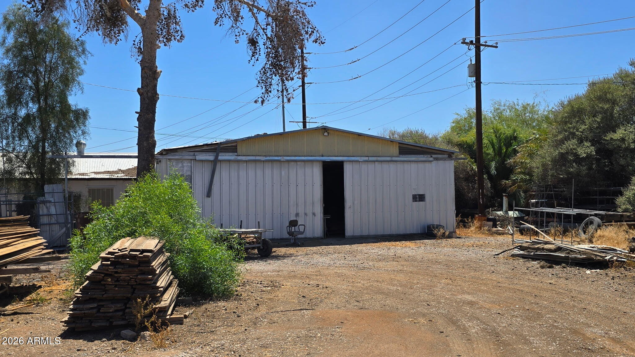 6803 South Miller Road Buckeye, AZ 85326 - Photo 26 of 50 a backyard of a house with table and chairs under an umbrella