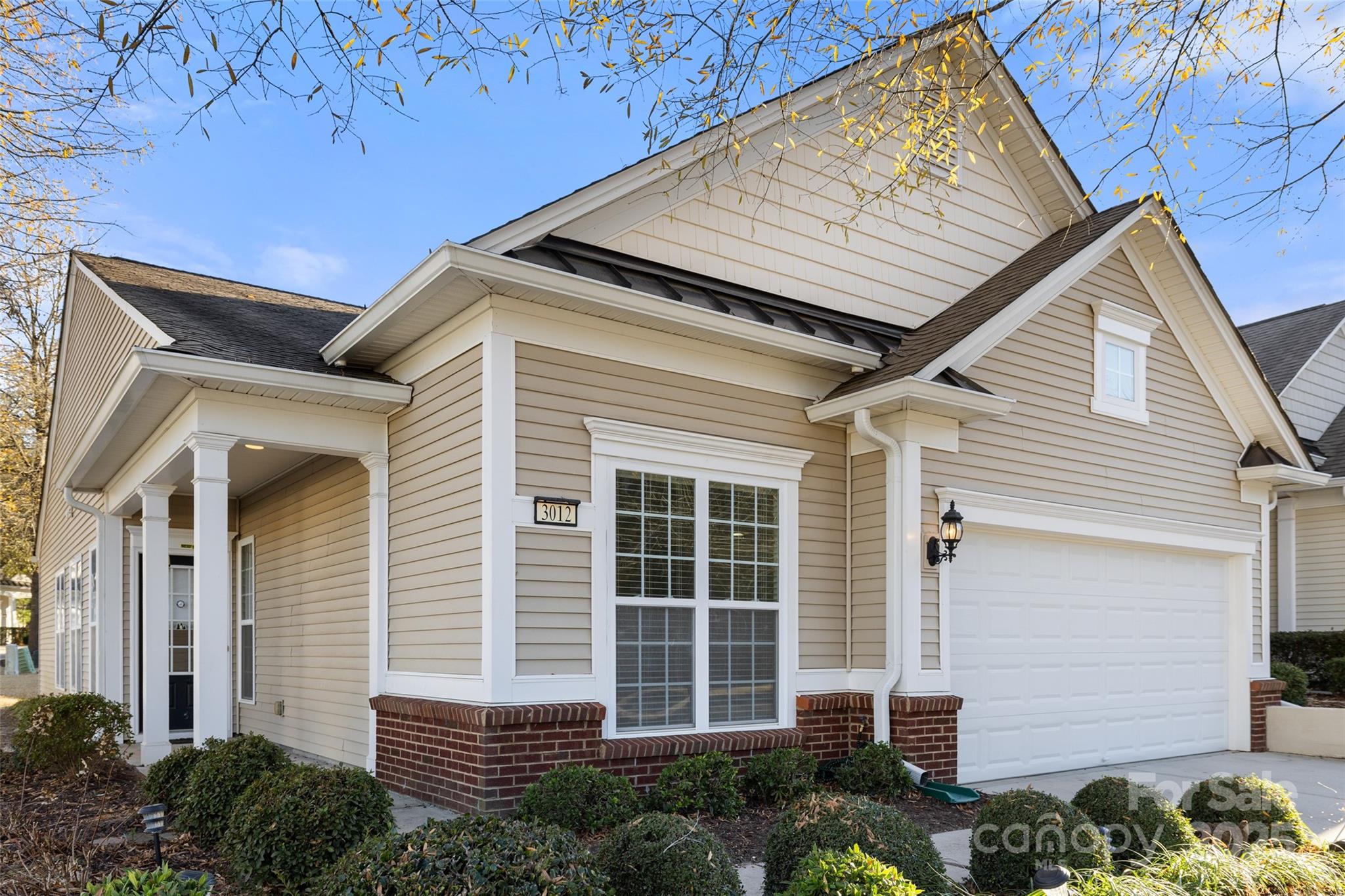 a front view of a house with a plants
