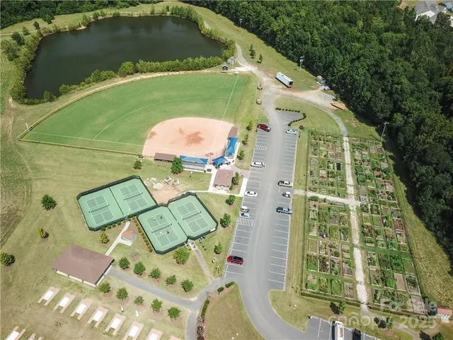 an aerial view of a house with swimming pool and green space